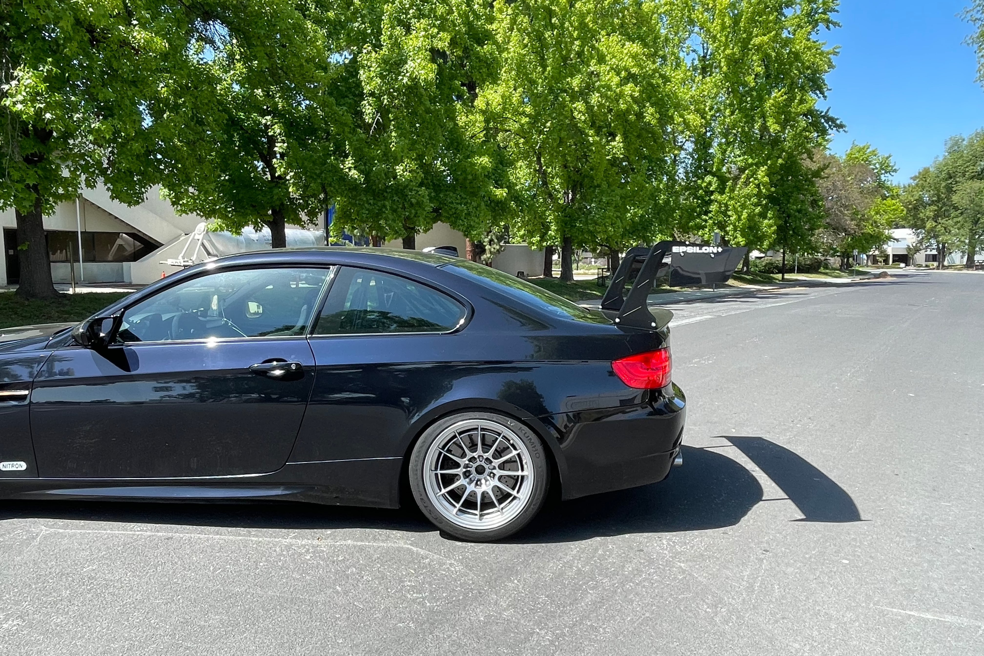 Side profile of a black BMW E92 M3 showing the GT wing height