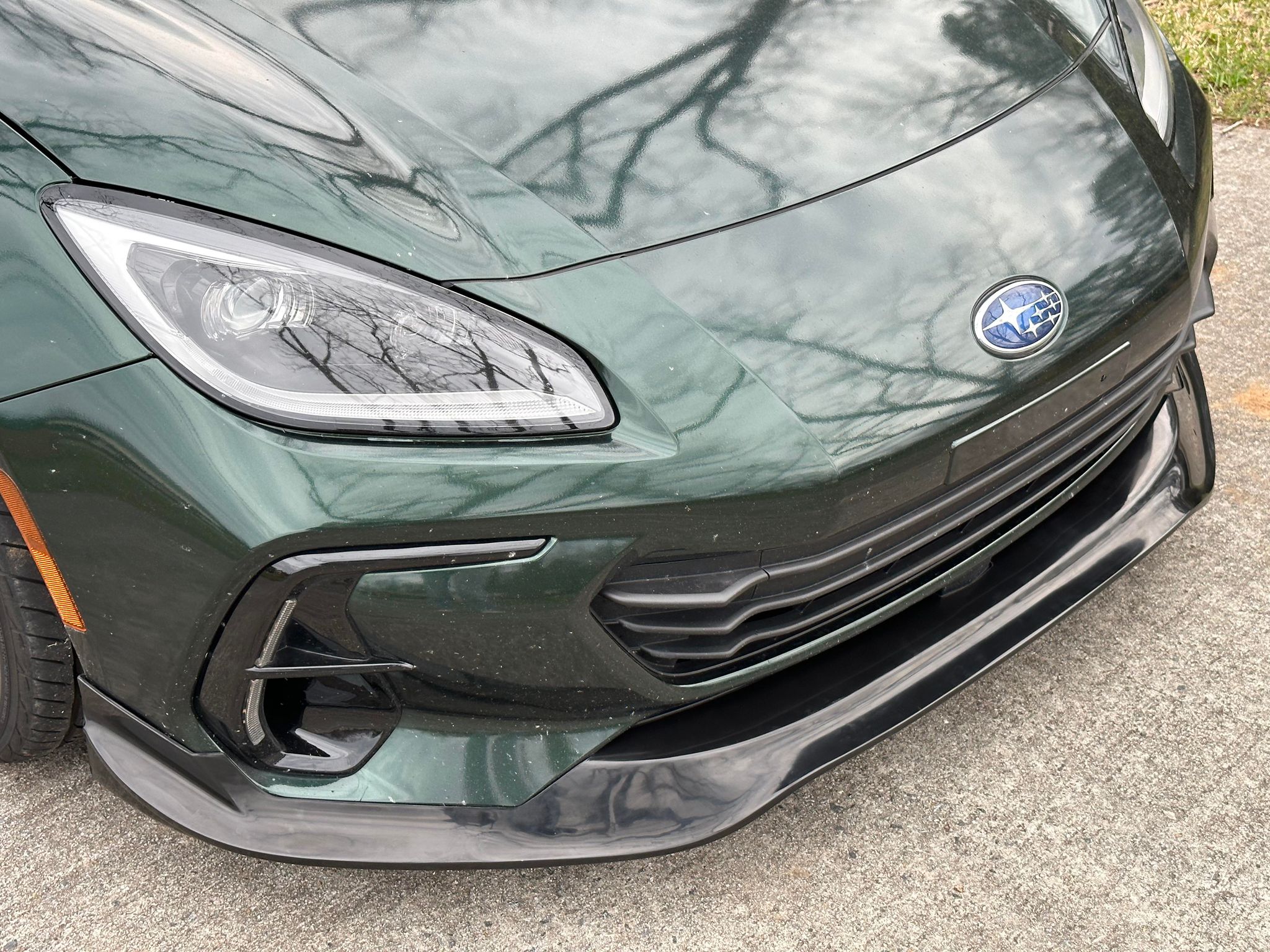 Front corner detail of the Epsilon+ front lip on a dark green Subaru BRZ ZN8