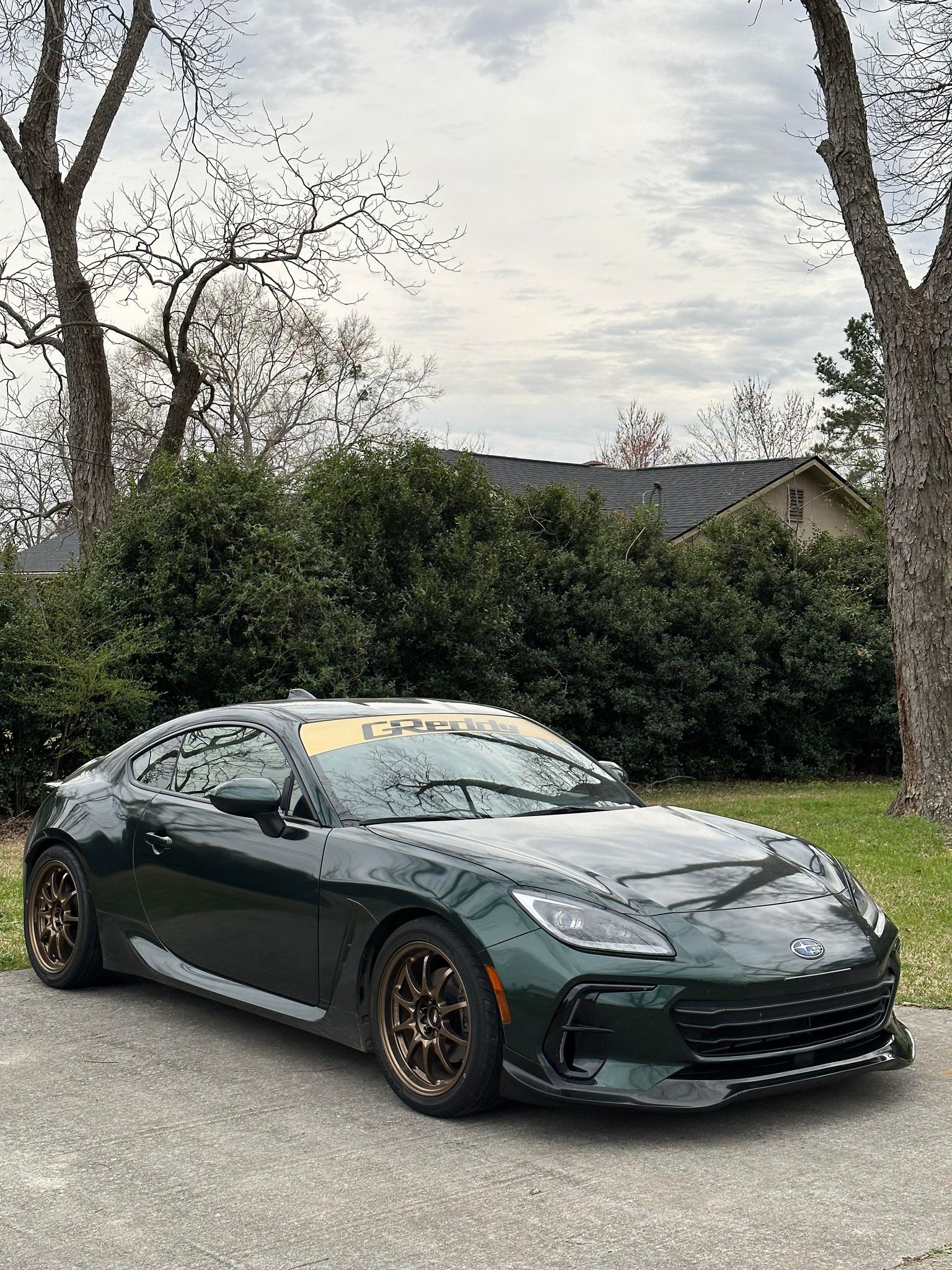 Dark green Subaru BRZ ZN8 with front lip parked on a residential street