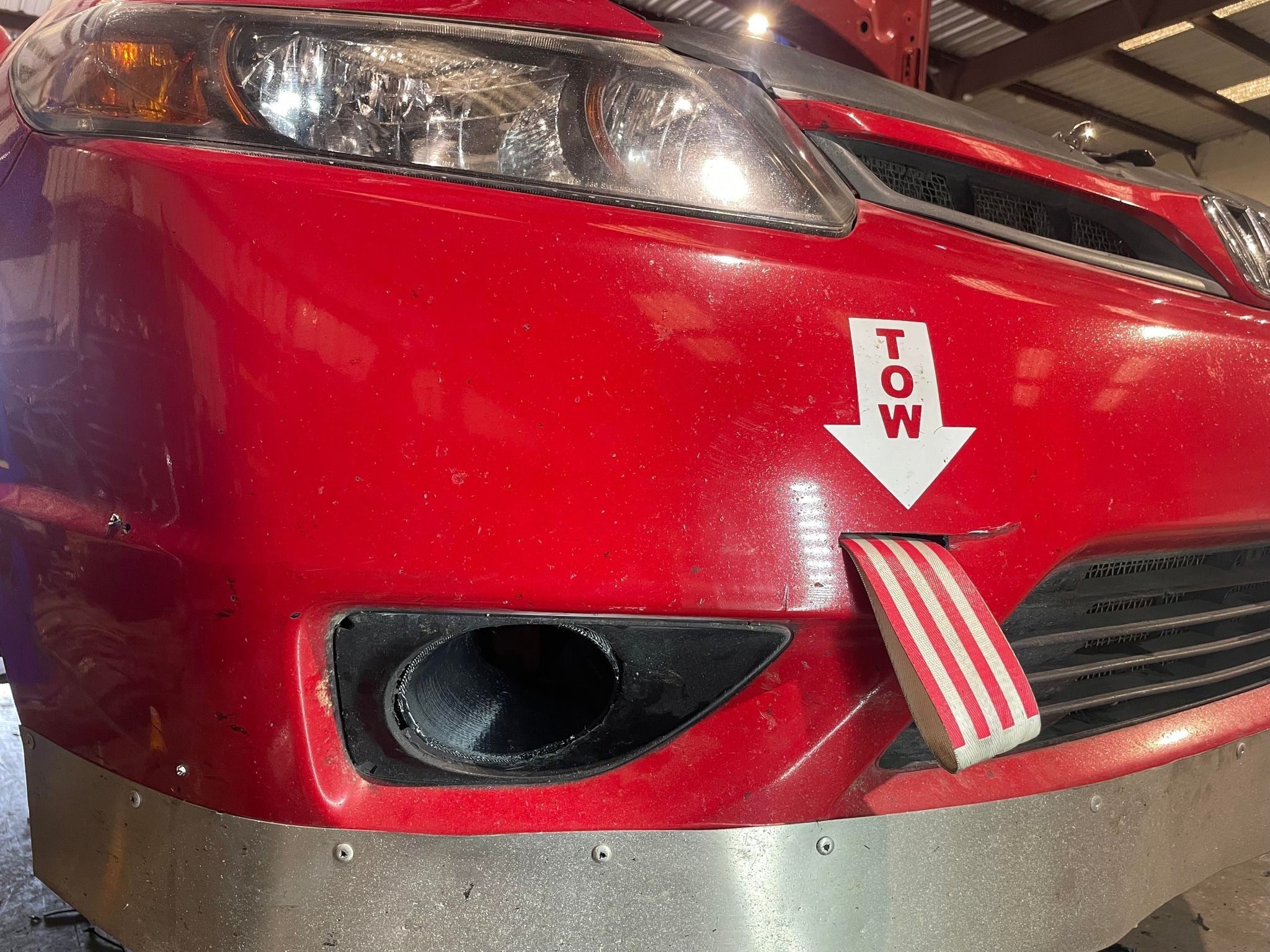 Rear three-quarter view of a red Civic Coupe FG2 with brake duct hose visible under the fender