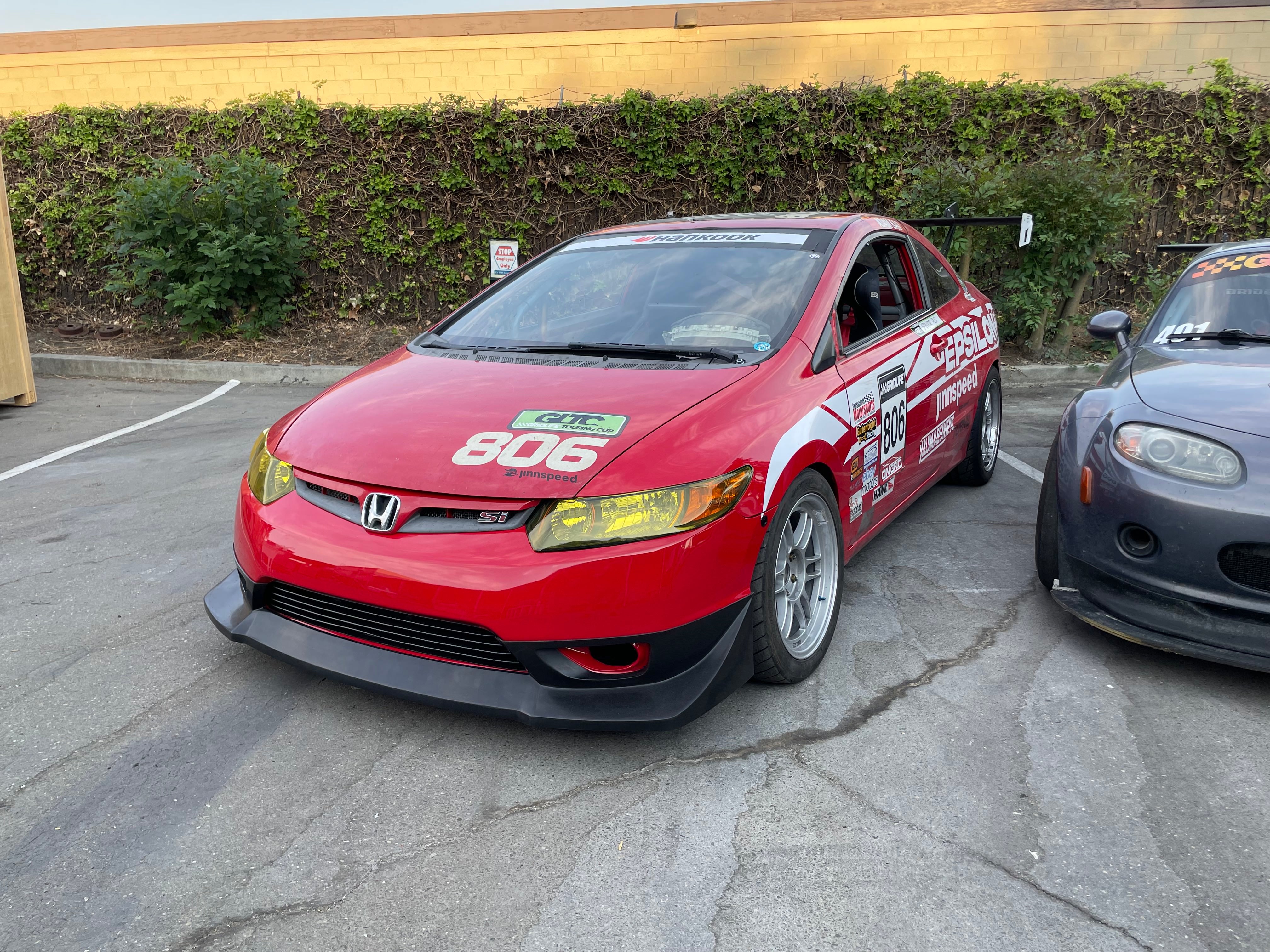 Front-on view of a red Honda Civic Coupe FG2 fitted with the front lip