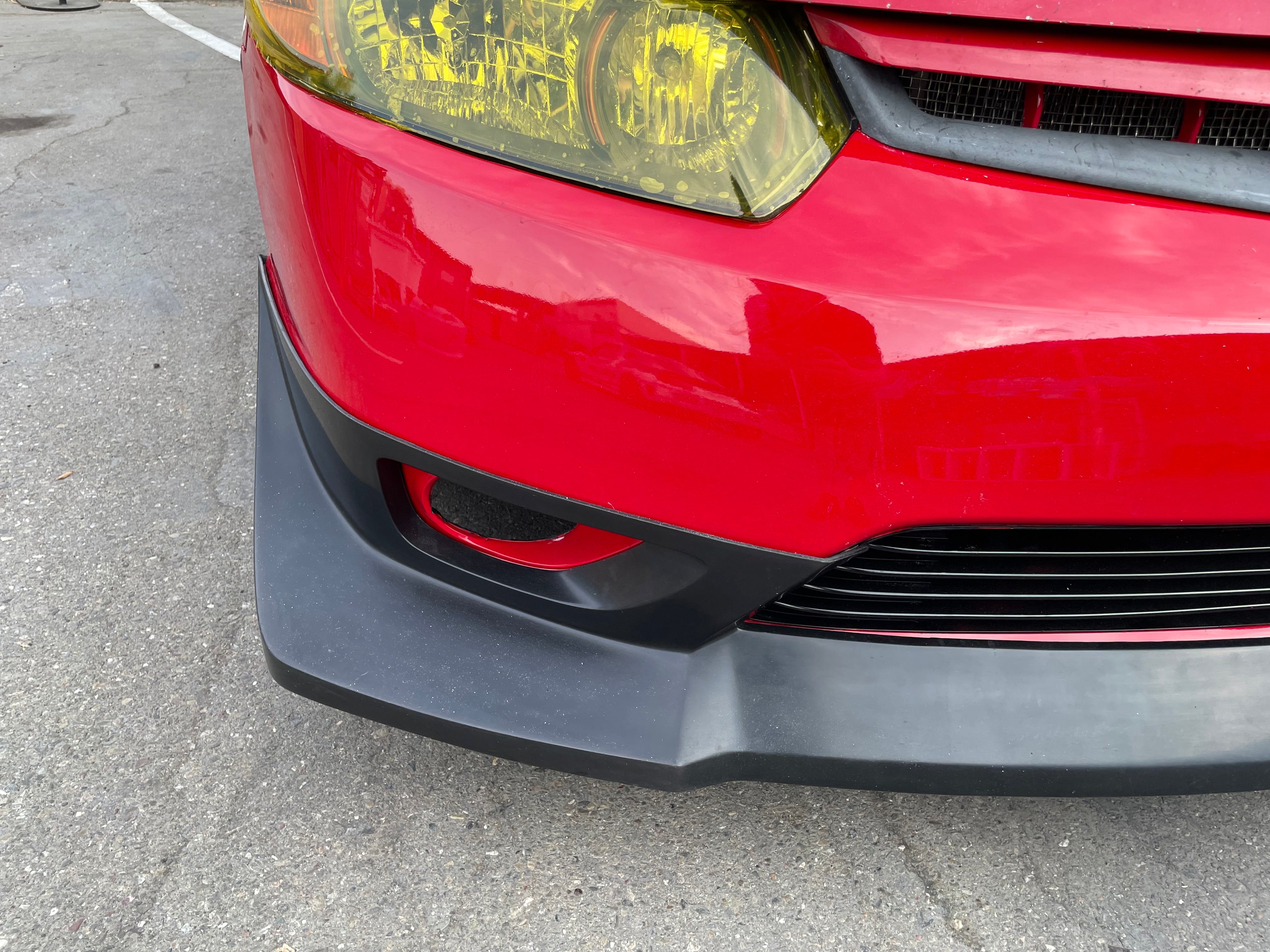 Close-up of the Epsilon+ front lip below the headlight on a red Civic Coupe