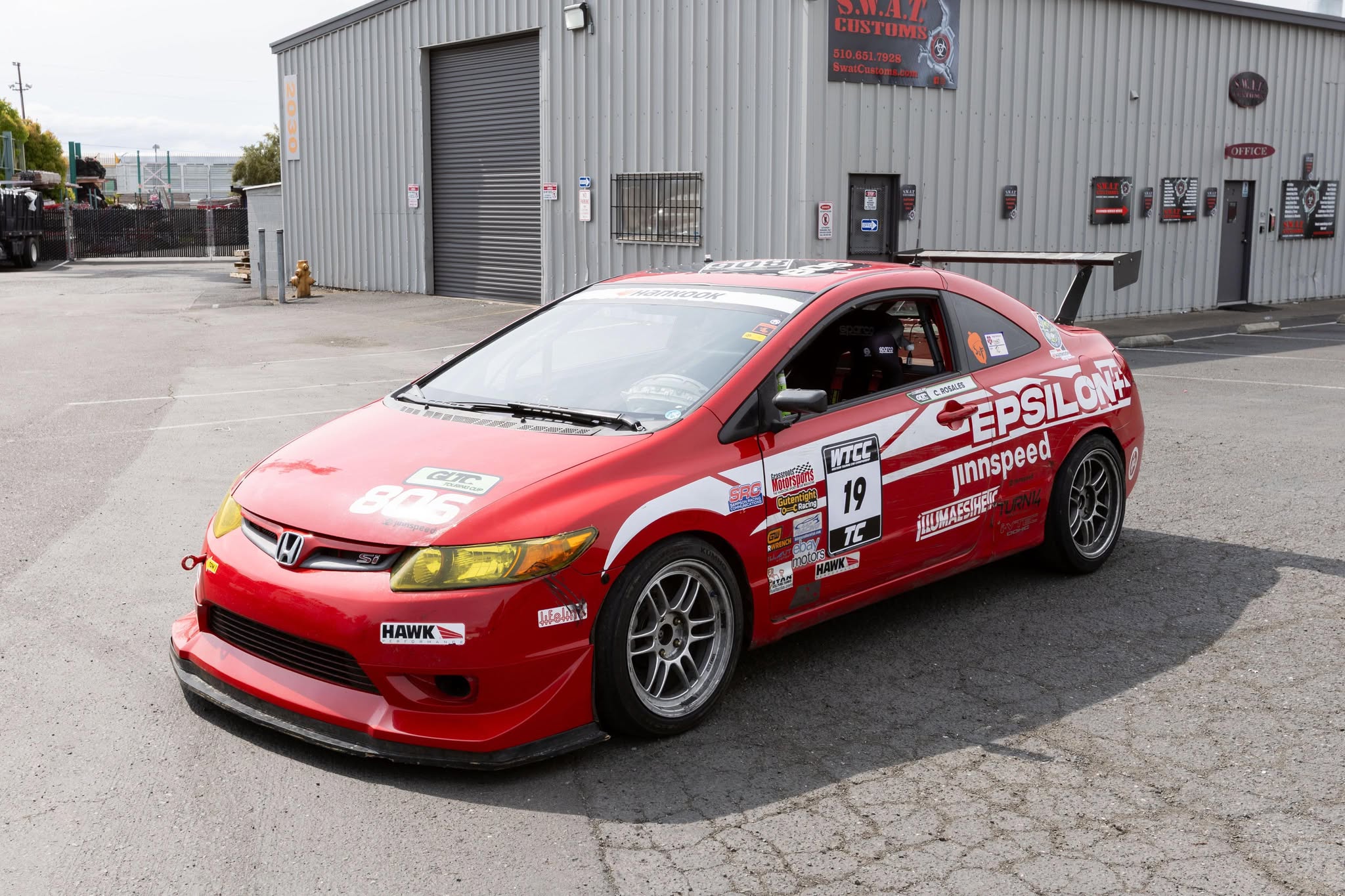 Front three-quarter view of a red Civic Coupe FG2 race car with front lip