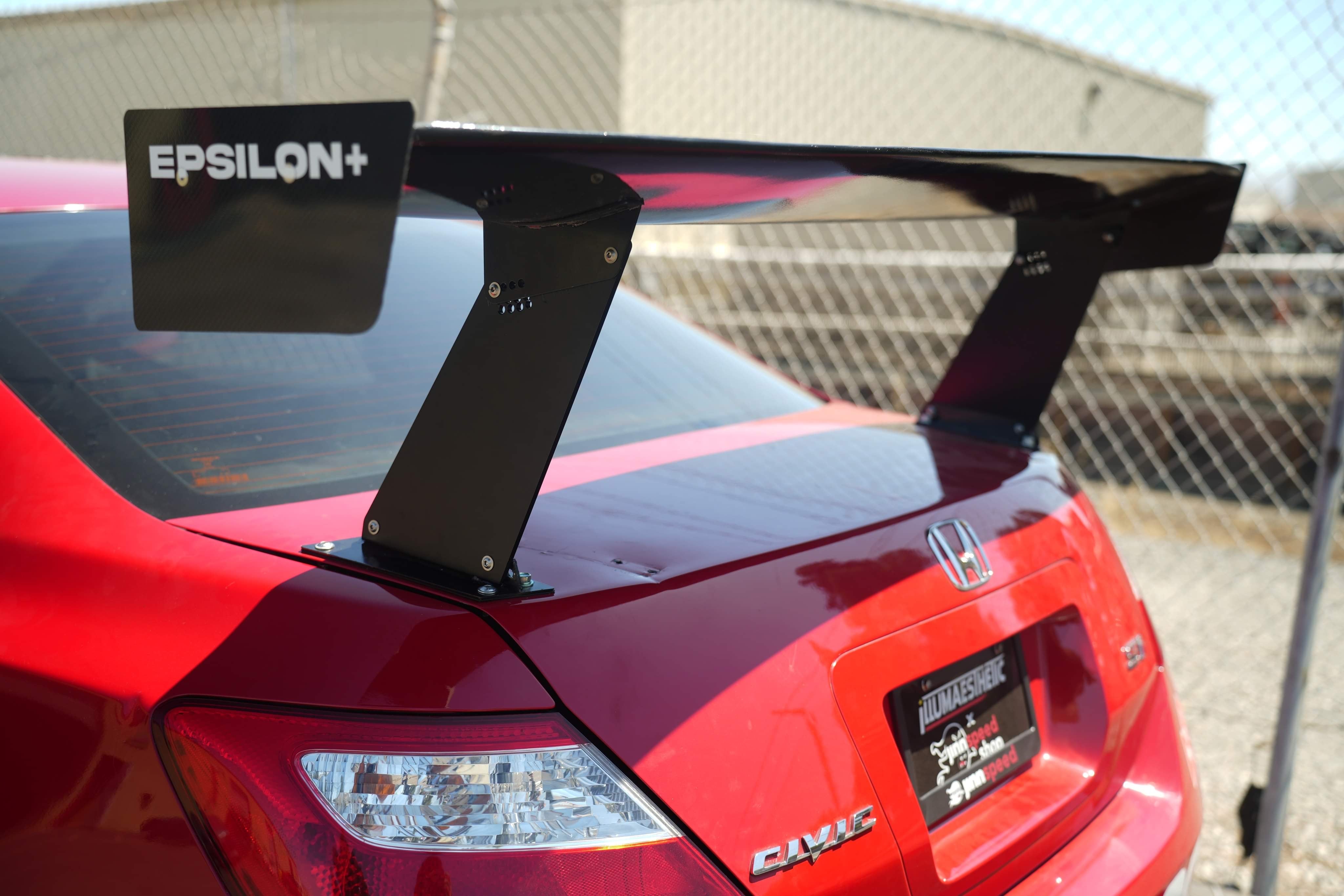 Close-up of the Epsilon+ GT wing endplate on a red Civic Coupe FG2 trunk