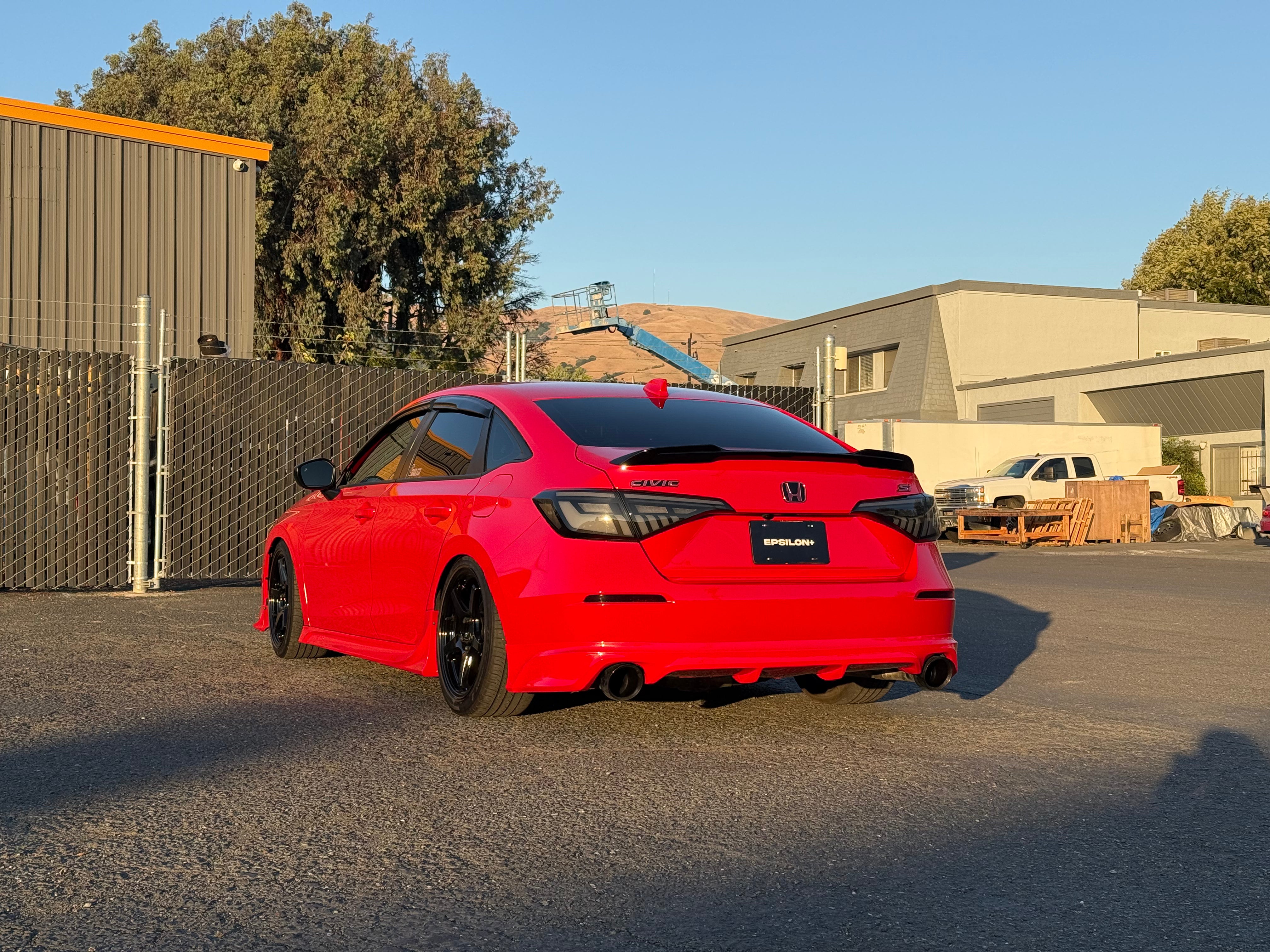 Red Honda Civic Sedan with the Epsilon+ rear lip parked outdoors