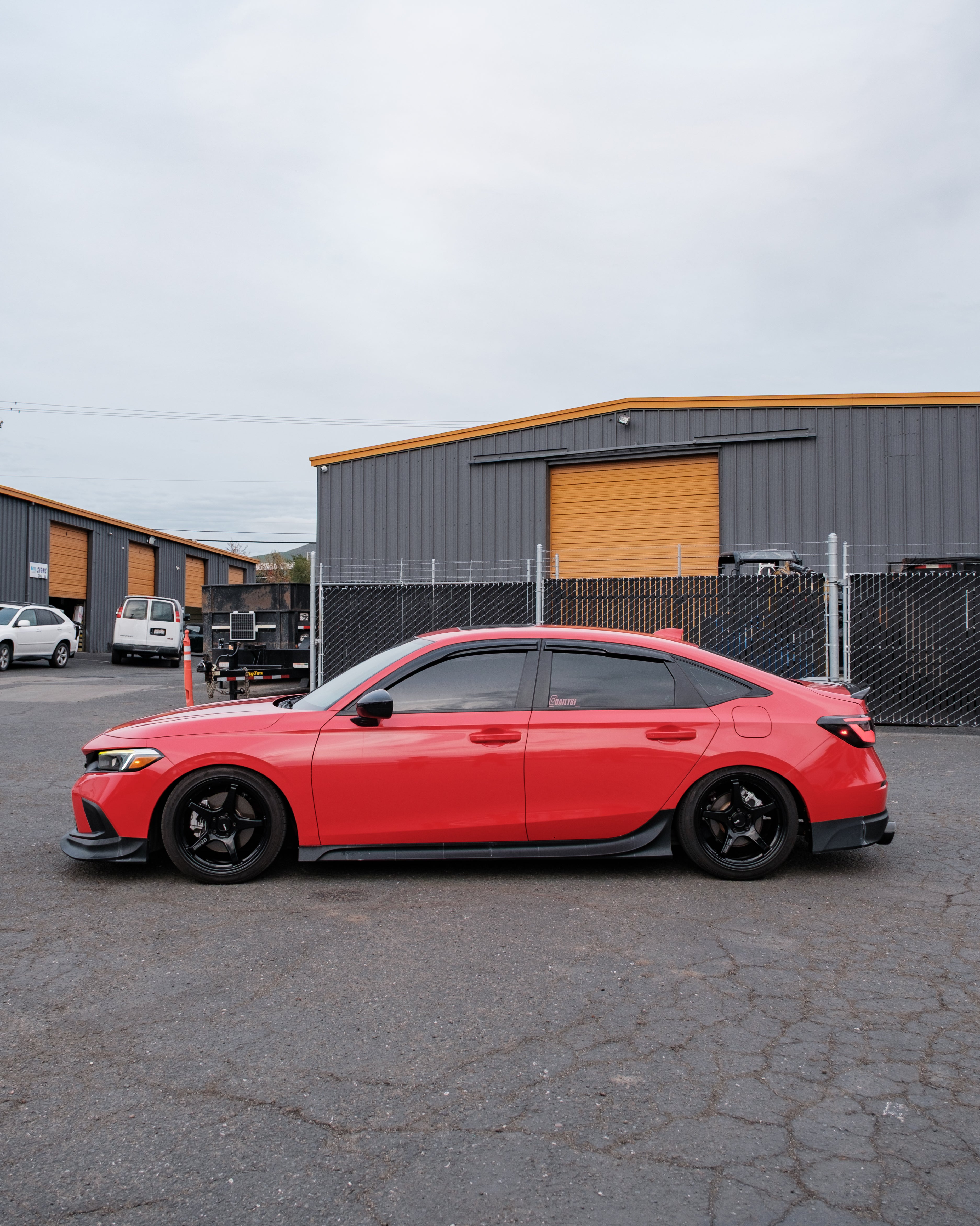 Red Honda Civic with the Epsilon+ side skirts in a parking lot
