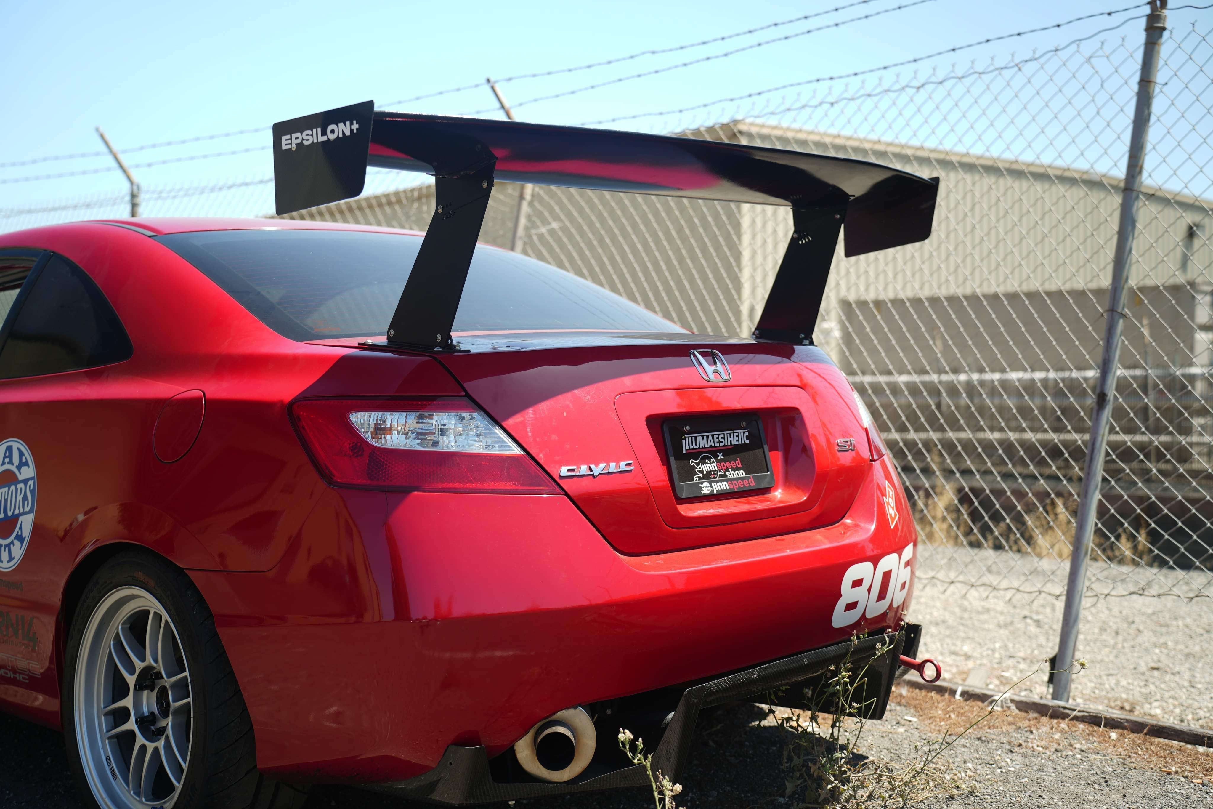 Rear view of a red Civic Coupe FG2 race car with GT wing, race number 806
