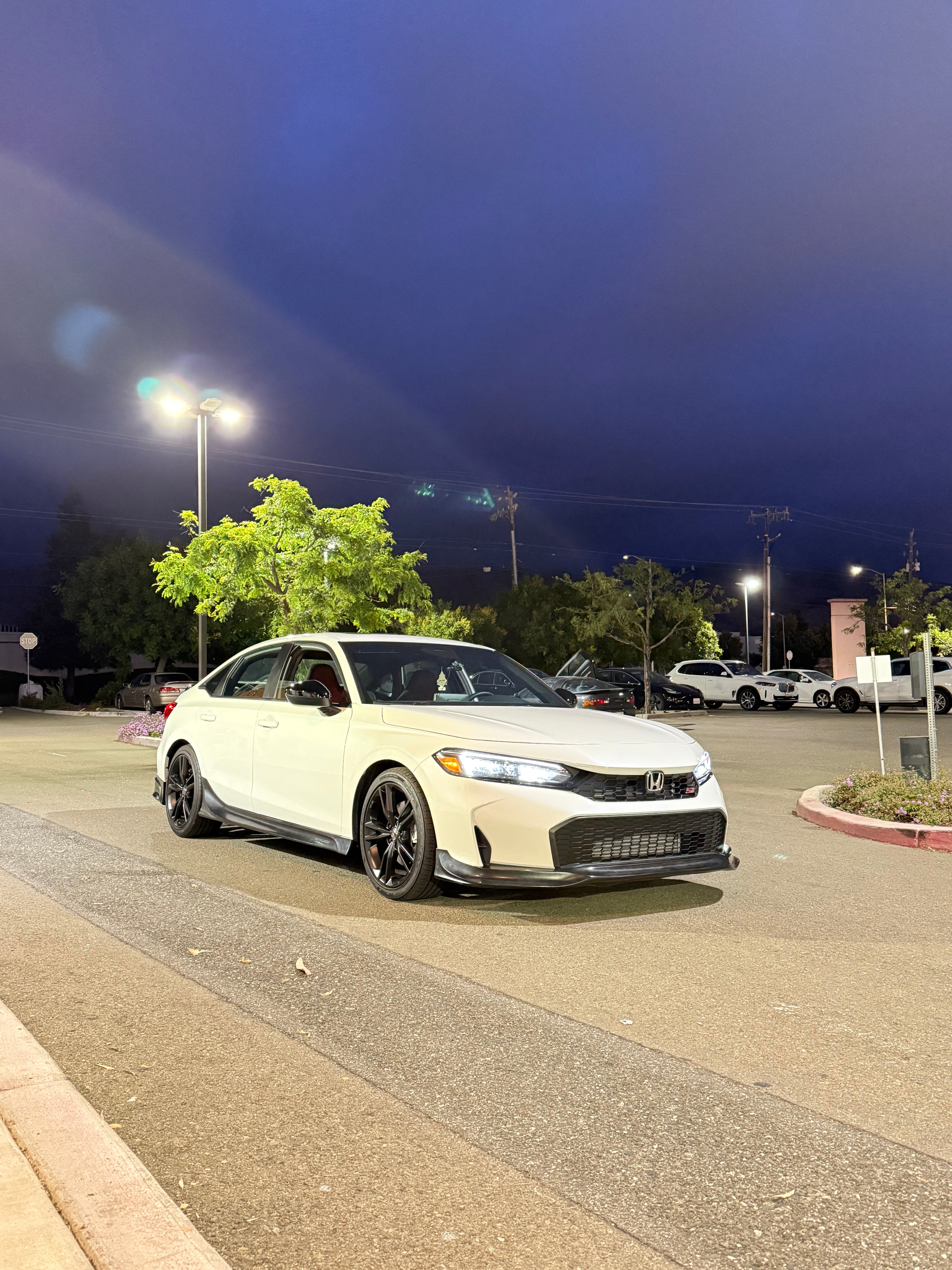 White Honda Civic Kouki with front lip parked under an evening sky