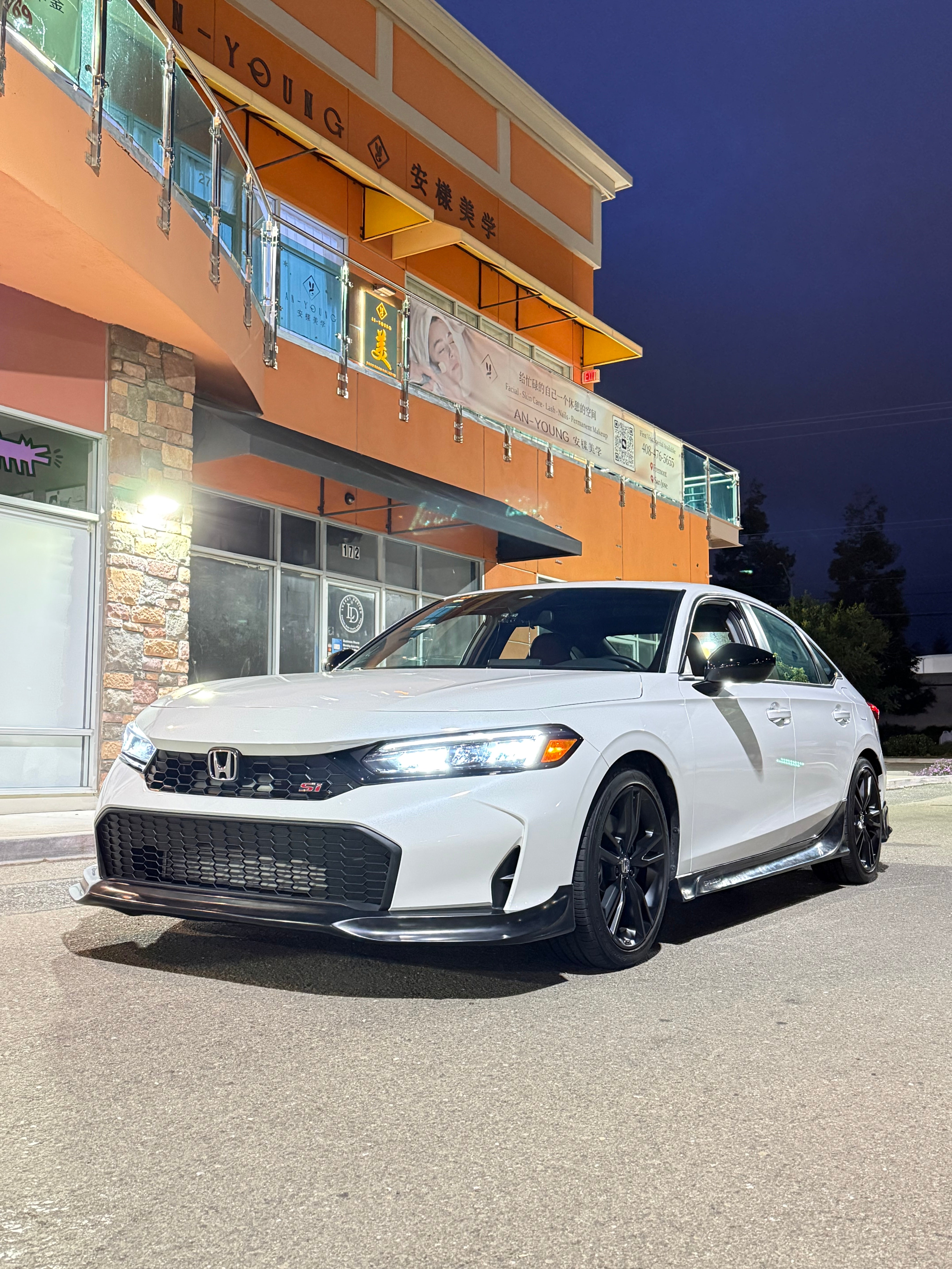 Front three-quarter view of a white Honda Civic Kouki with the Epsilon+ front lip