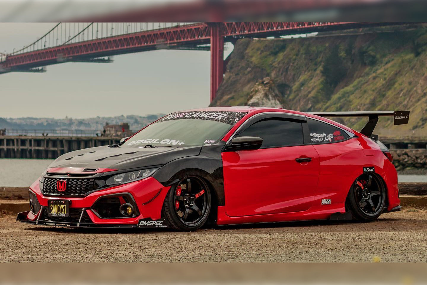 Red and black Civic Si Coupe with GT wing parked near the Golden Gate Bridge