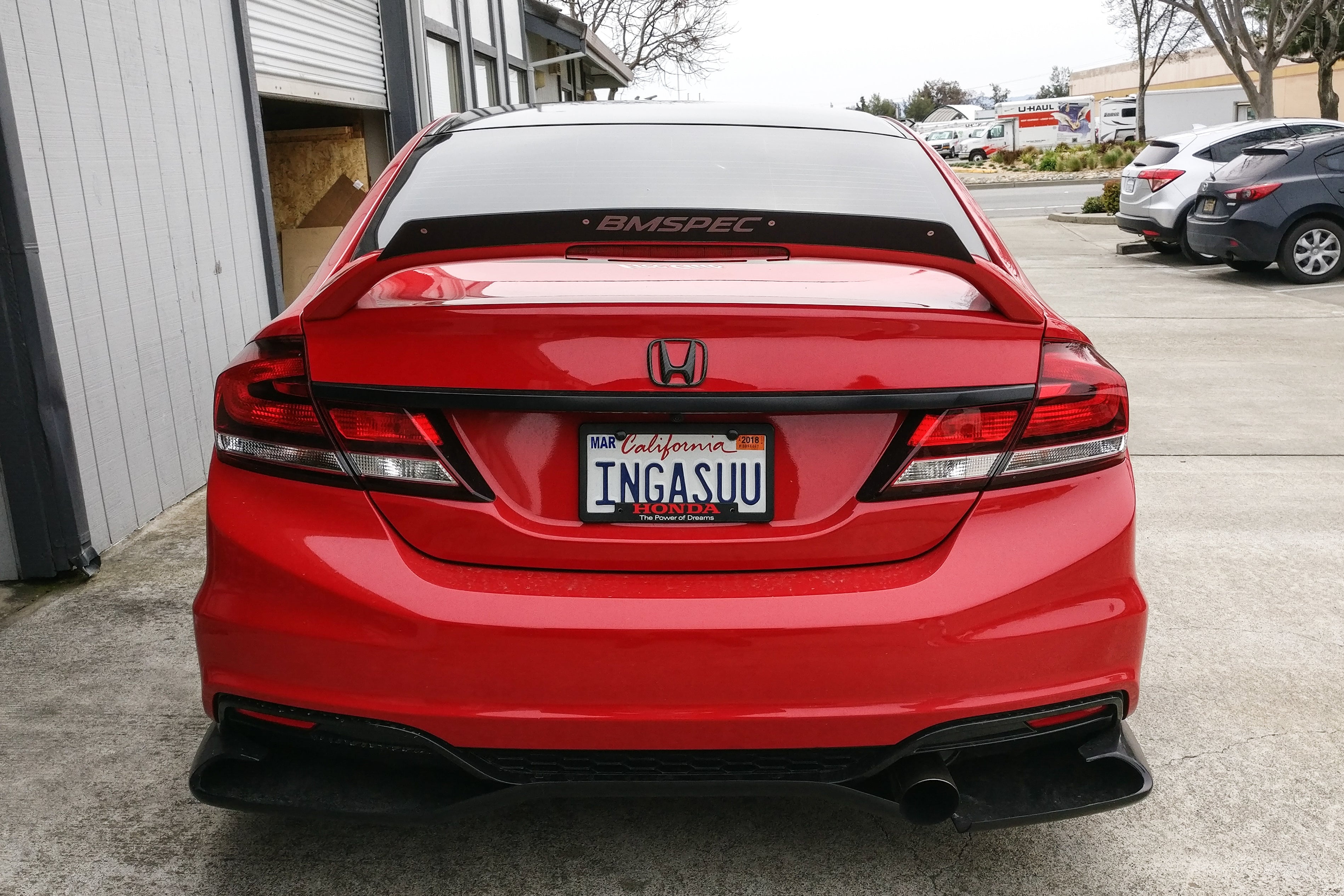 Rear view of a red Civic Si Sedan FB6 Kouki showing the spoiler extension and taillights
