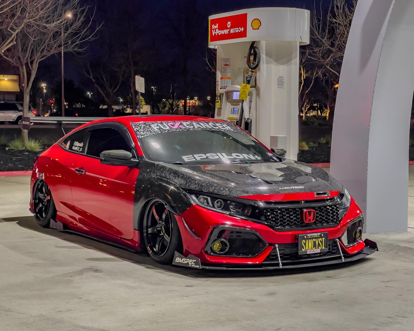 Red and black Civic Si Coupe with GT wing at a gas station at night