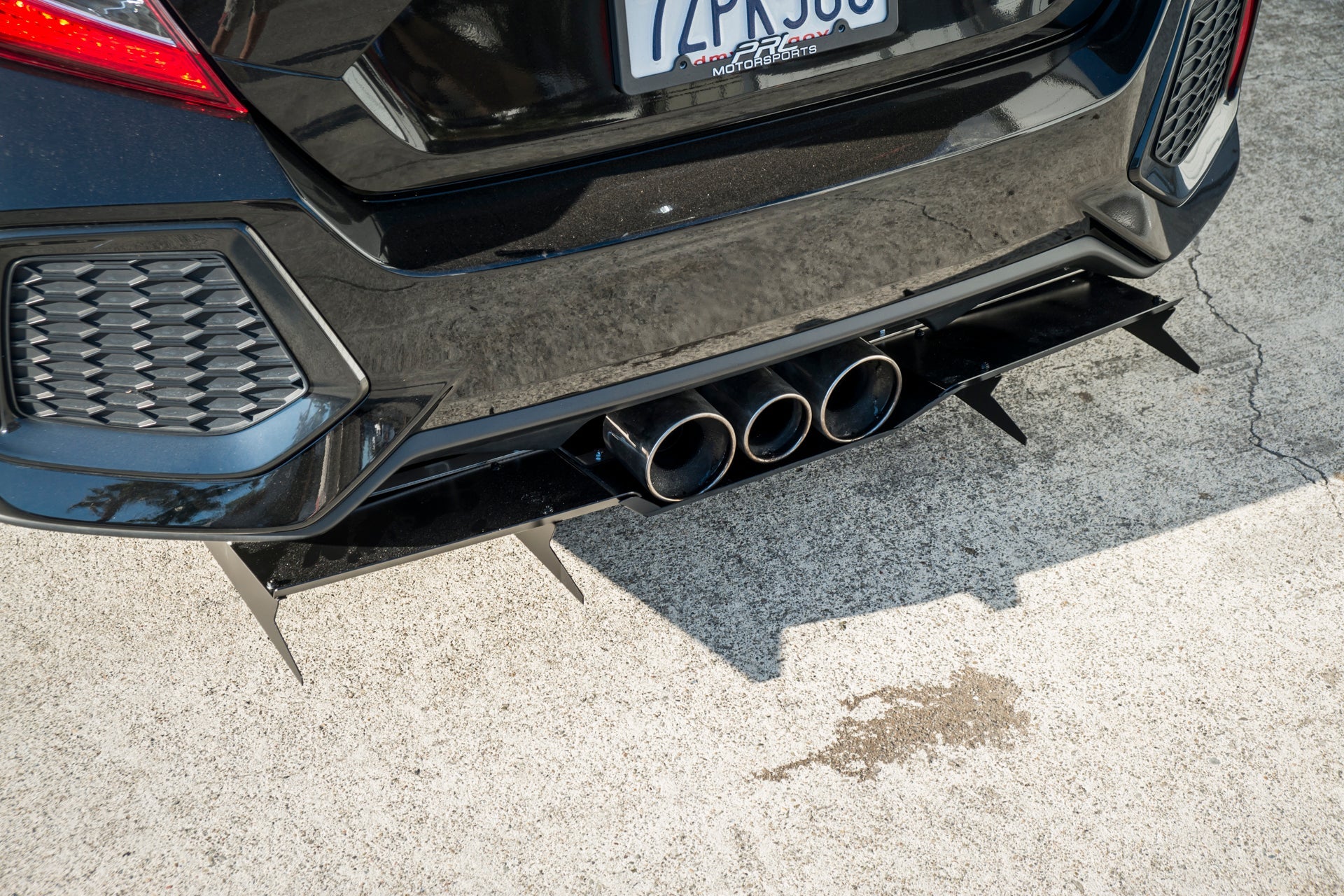 Close-up underside view of the rear diffuser on a black Civic Si Sedan