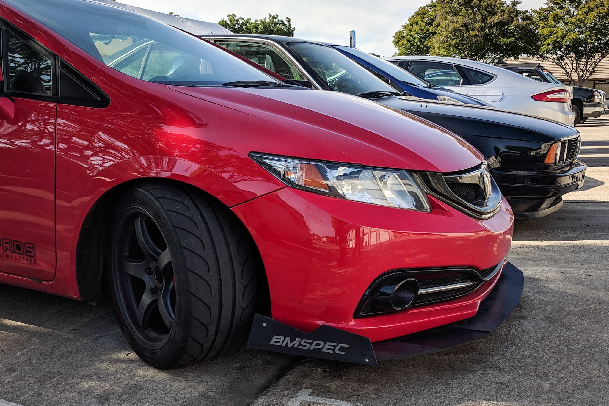 Close-up front view of the front splitter on a red Civic Si Sedan FB6 Kouki bumper