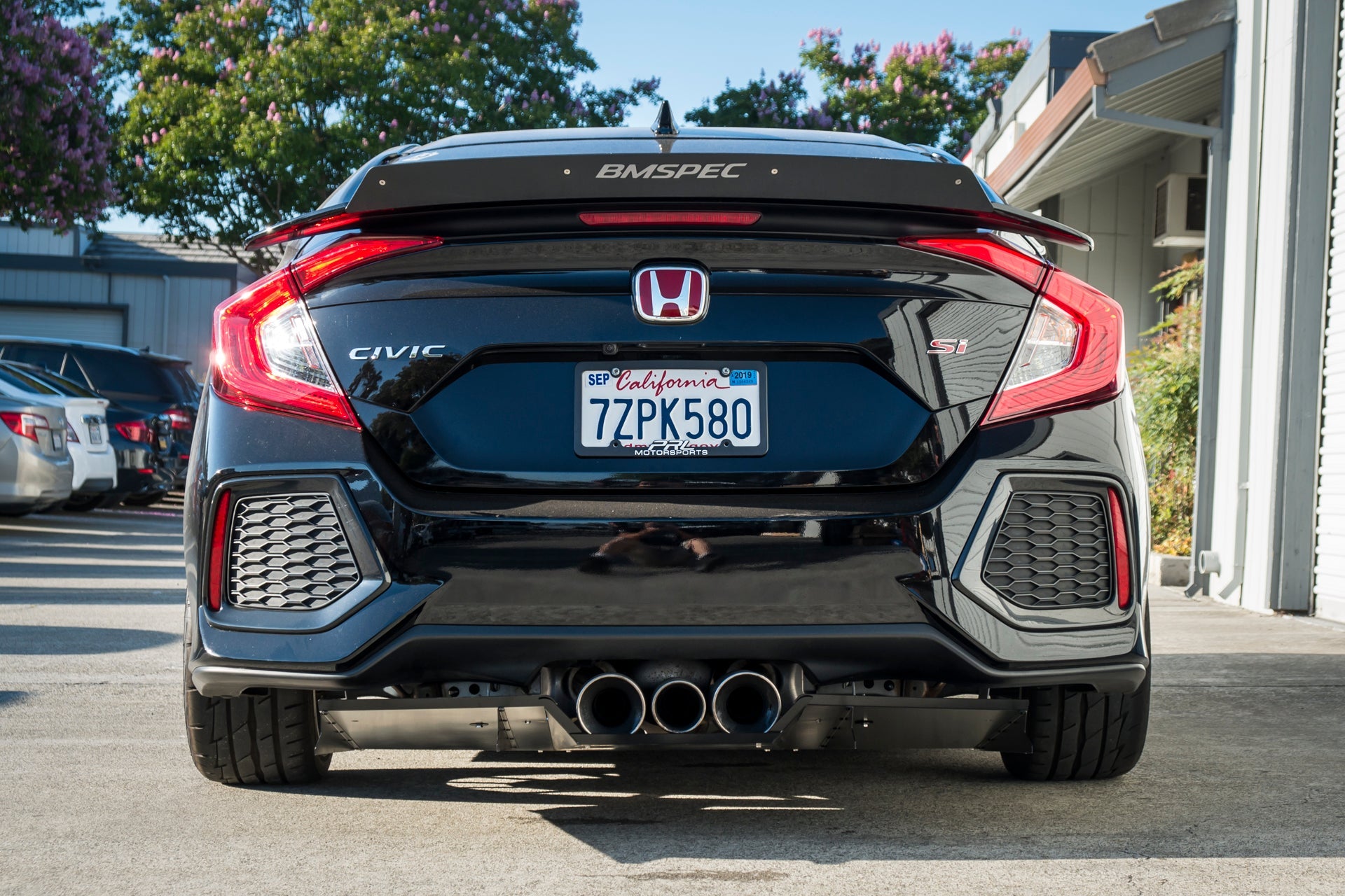 Rear view of a black Civic Si Sedan showing the diffuser and taillights