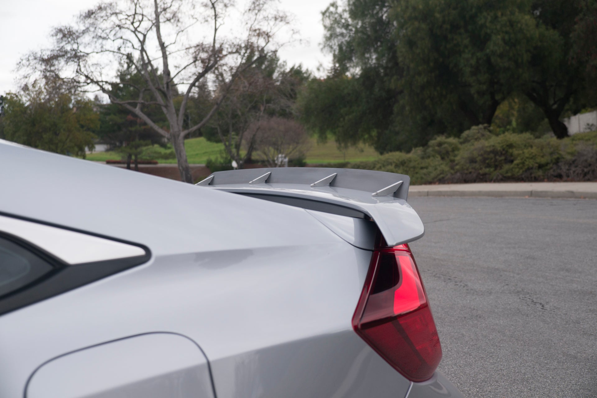 Close-up of the spoiler extension mounted on a silver Civic Si Sedan trunk lid