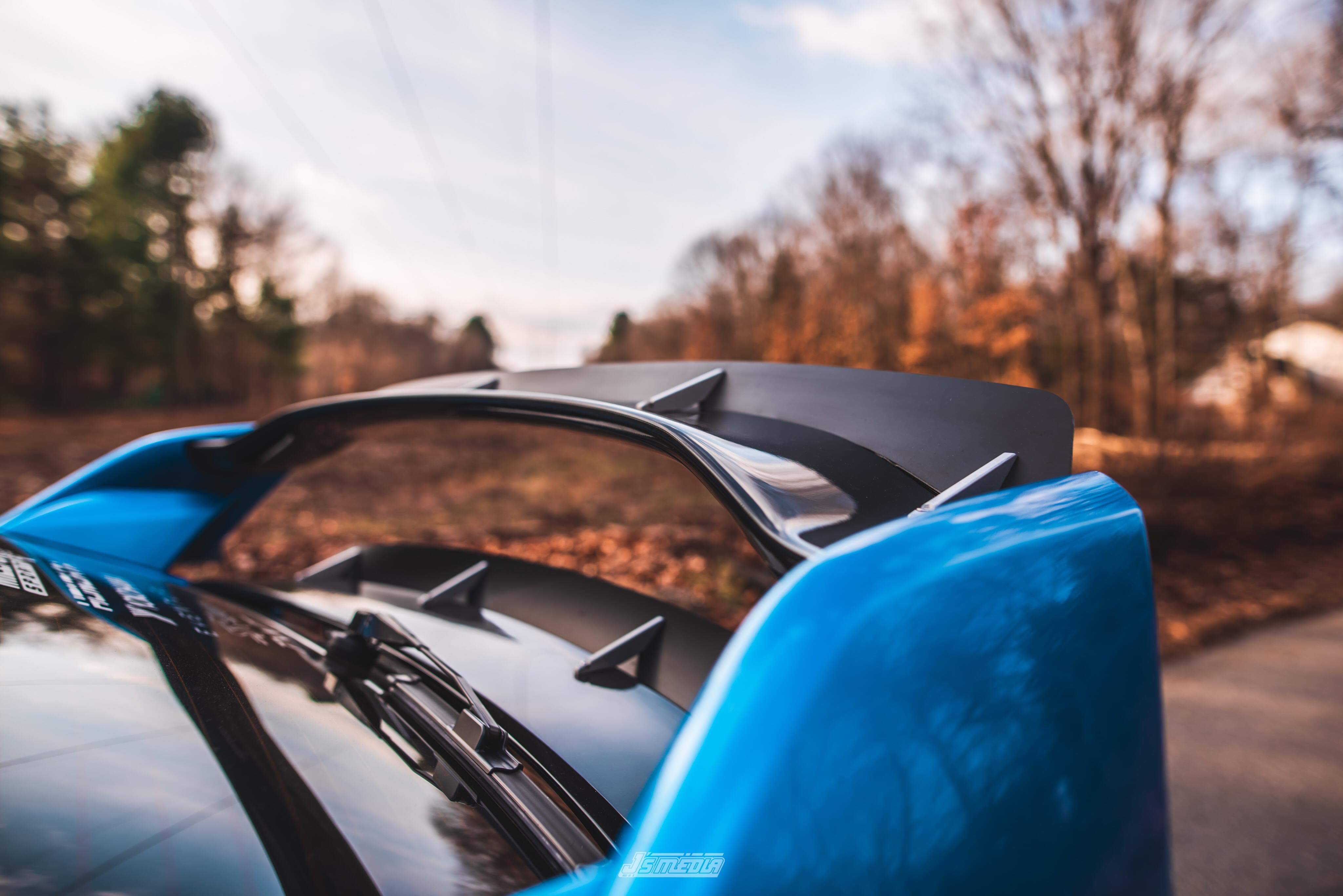 Close-up of the double spoiler extension mounted on a blue Civic Type R wing