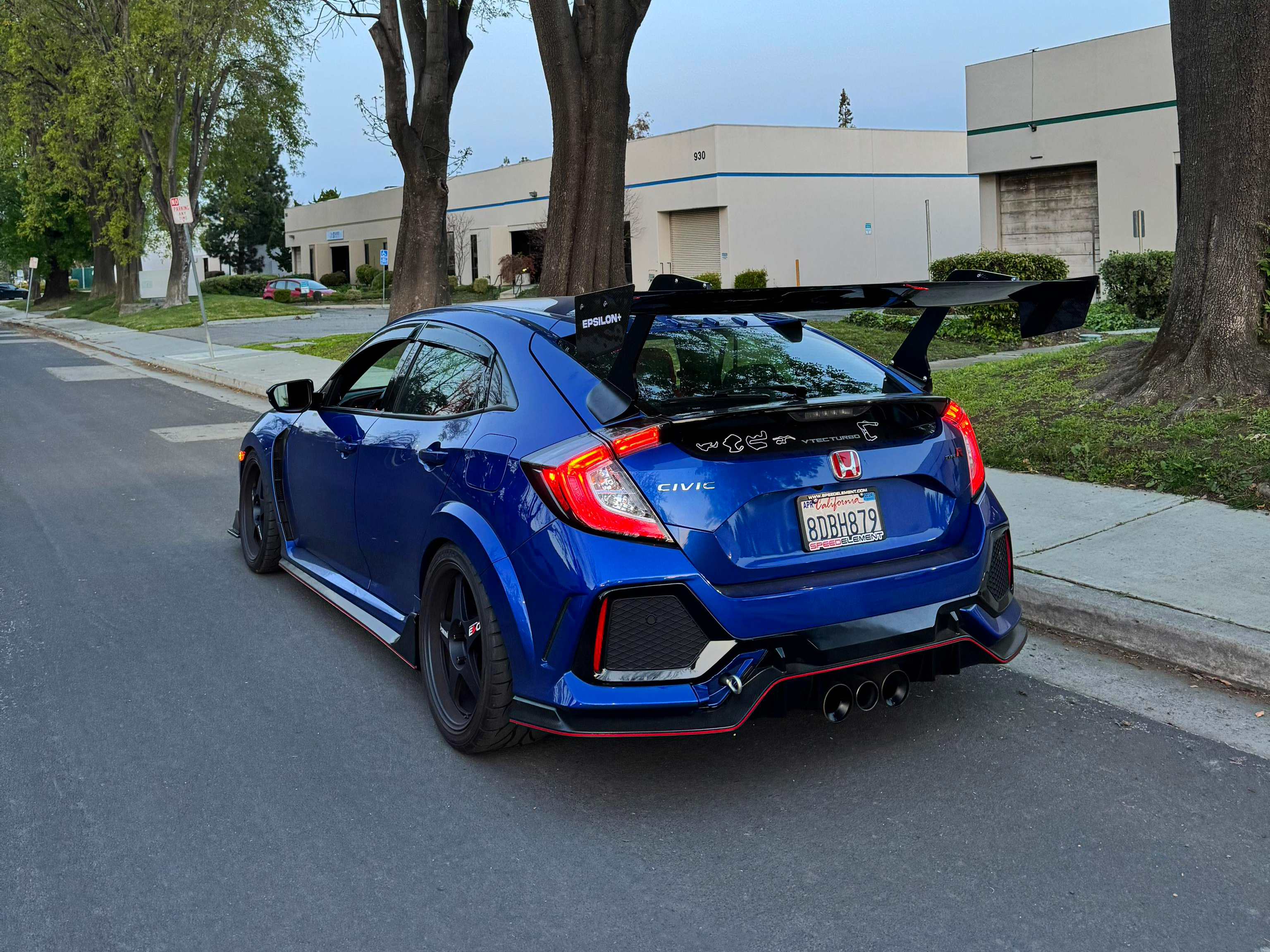 Rear three-quarter view of a blue Honda Civic Type R FK8 with Epsilon+ carbon fiber GT wing