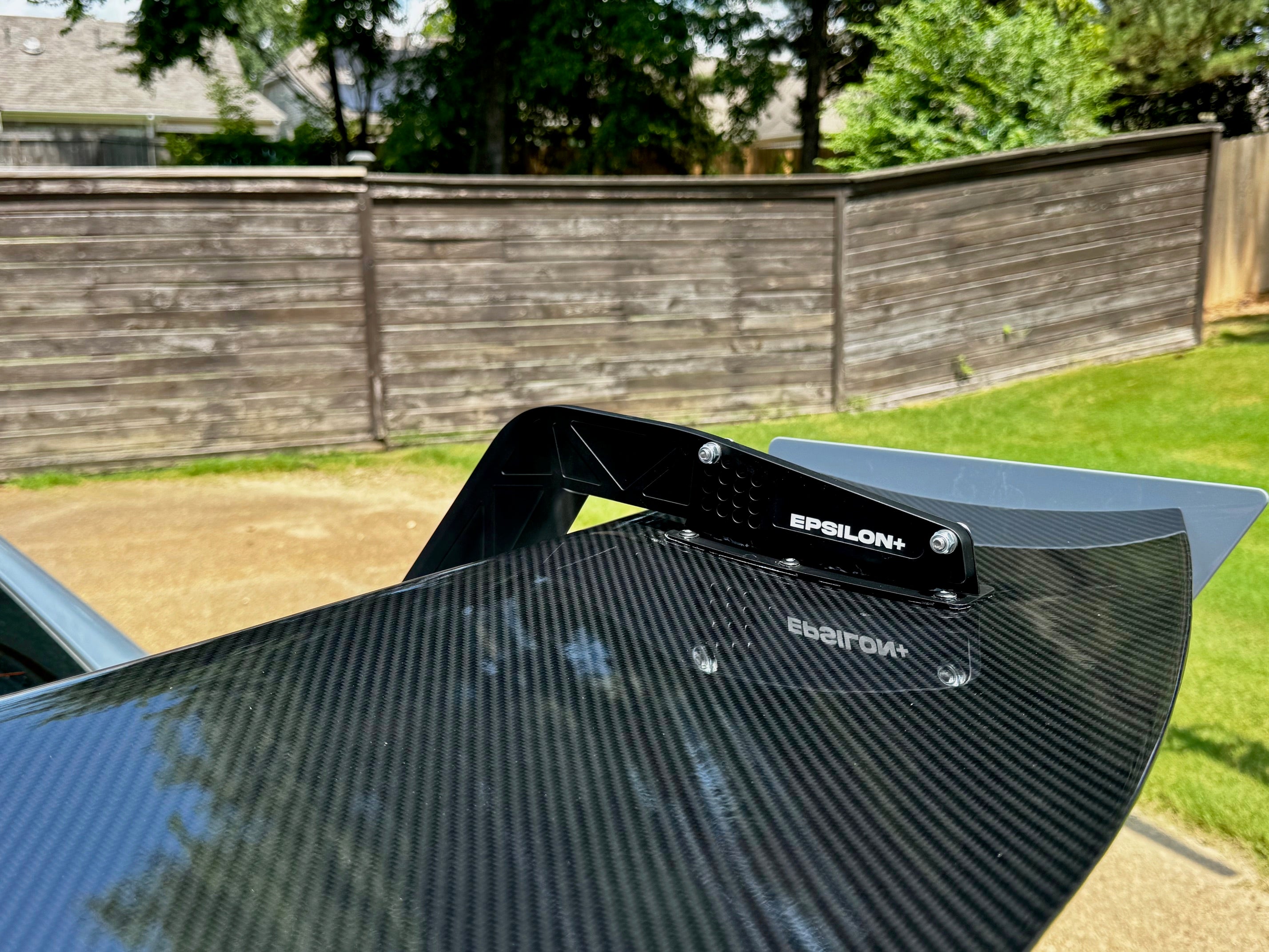 Close-up of the carbon fiber GT wing blade and Epsilon+ branding on a Civic Type R FL5