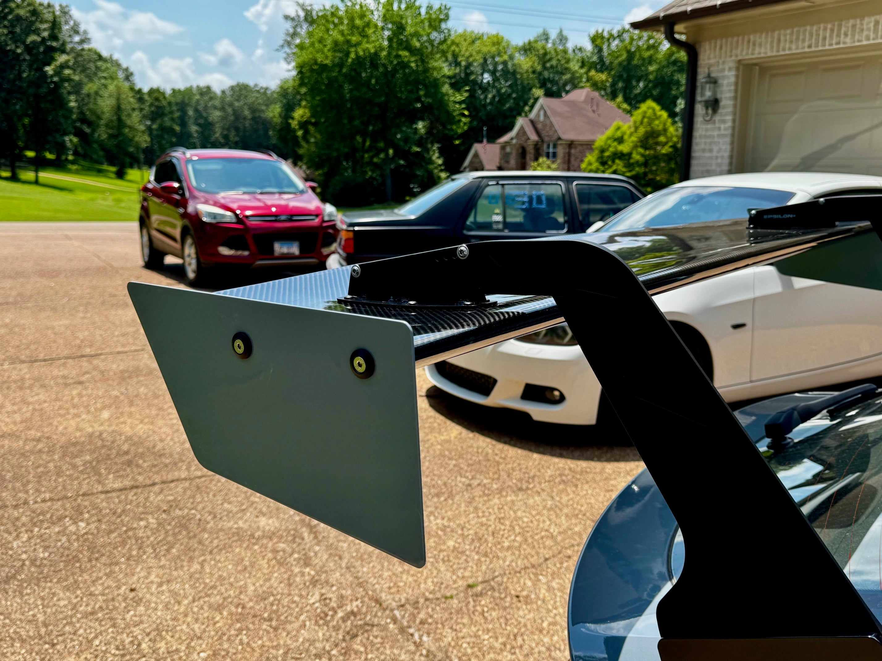 Close-up of the GT wing endplate and mounting hardware on a Civic Type R FL5