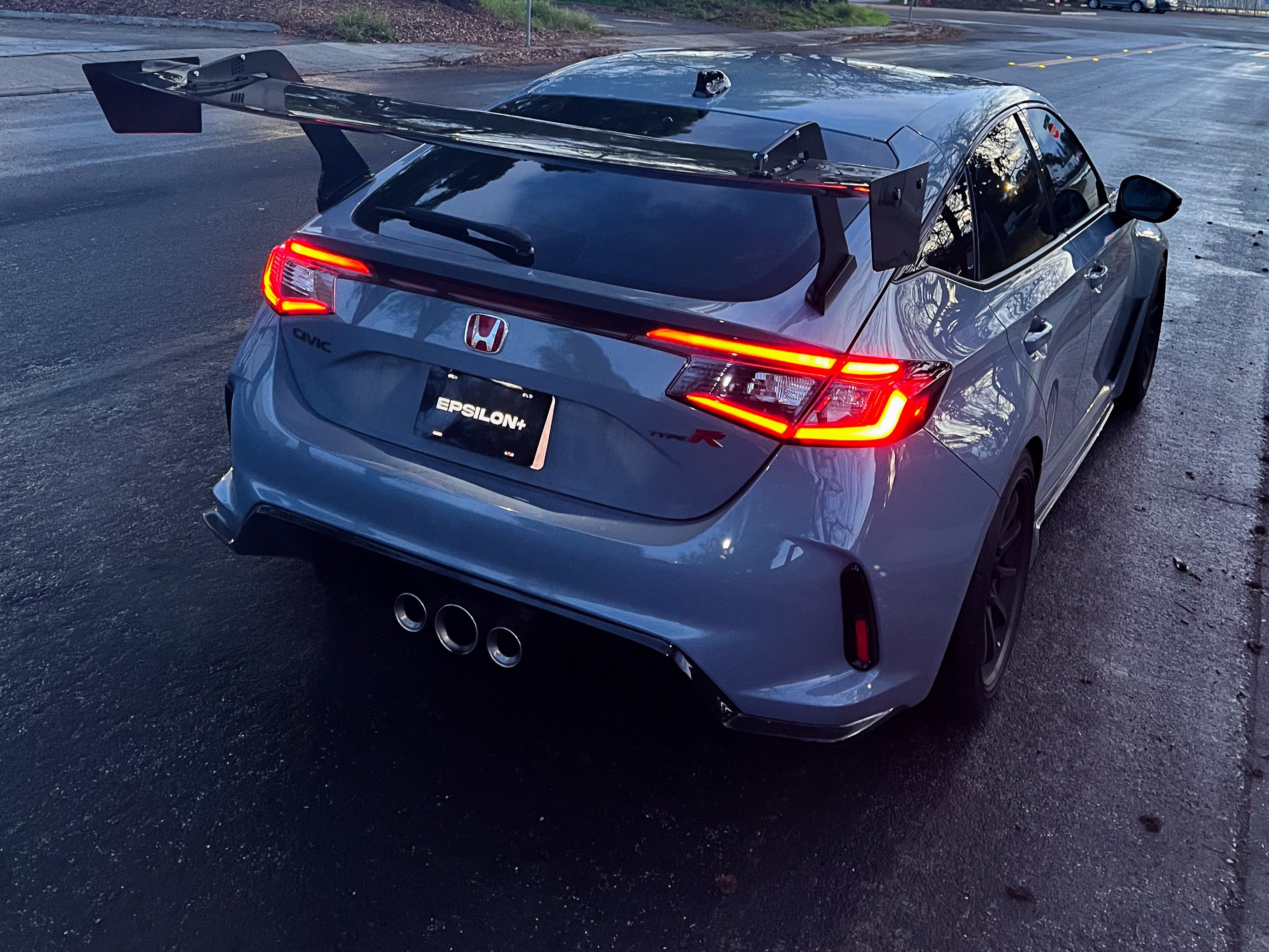 Rear view of a gray Civic Type R FL5 with GT wing at night