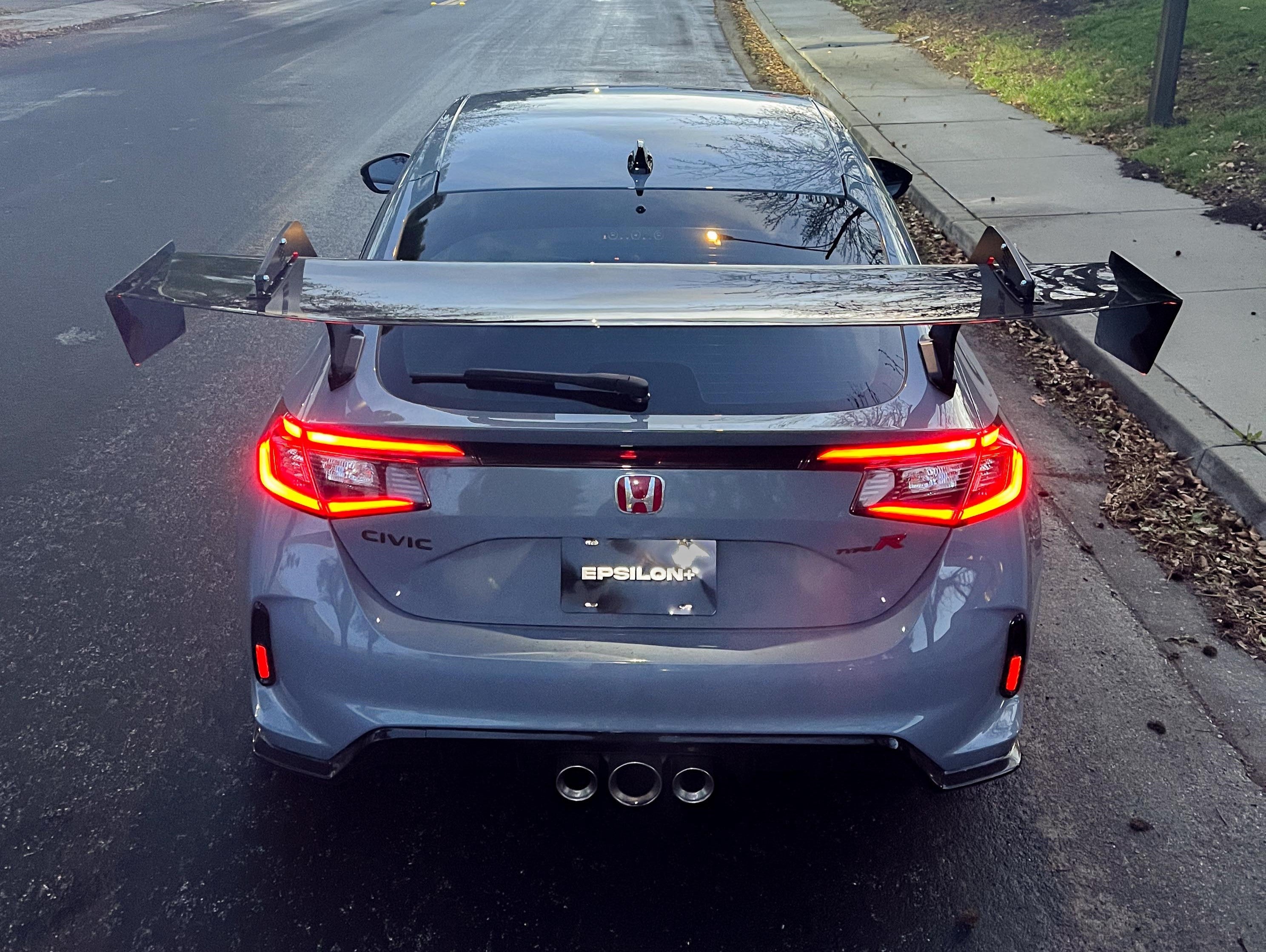 Rear view of a gray Honda Civic Type R FL5 with GT wing and triple exhaust