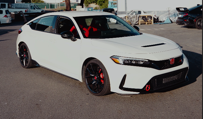 Front three-quarter view of a white Honda Civic Type R FL5 fitted with the GT wing