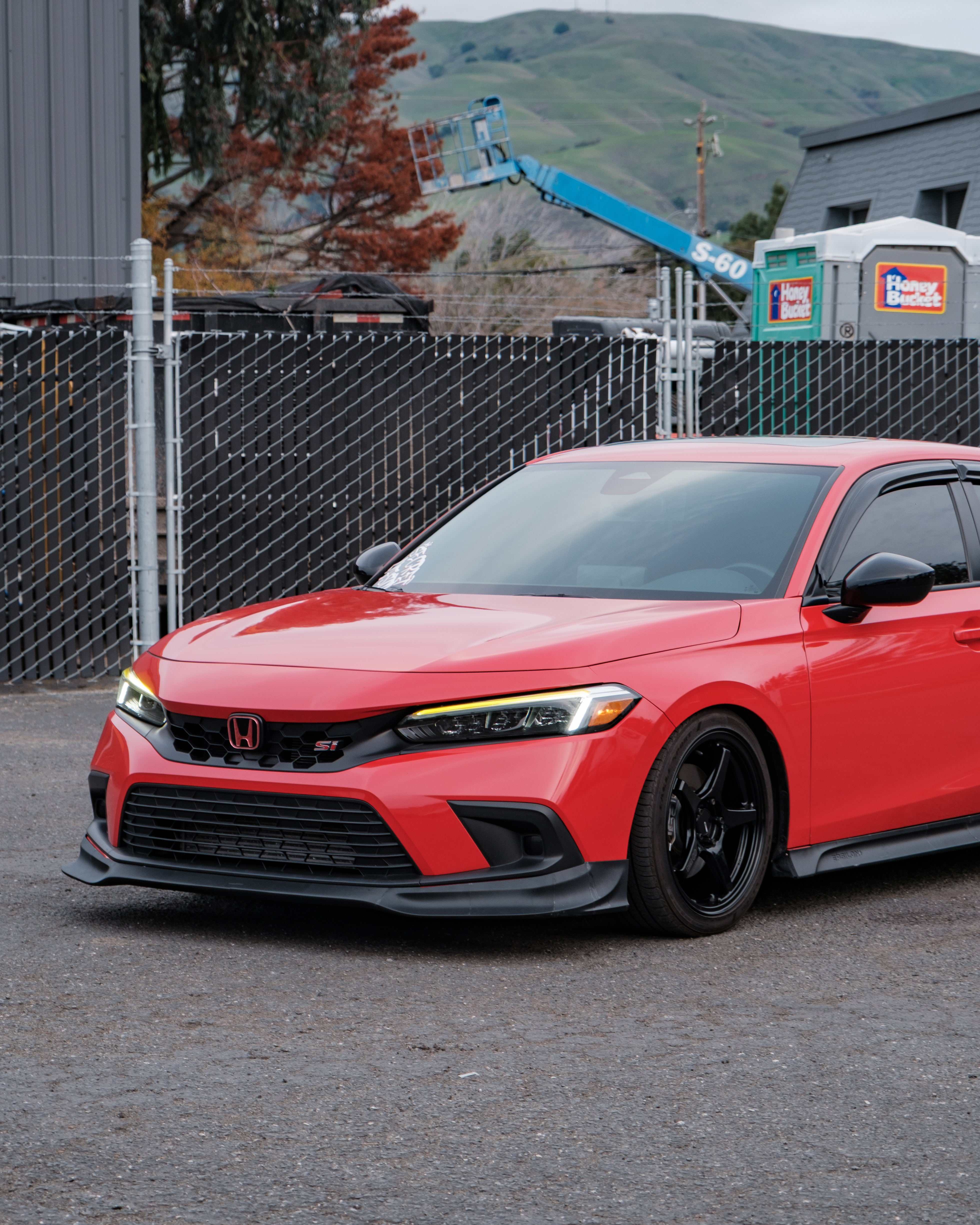 Low front three-quarter view of a red Honda Civic with the Epsilon+ front lip