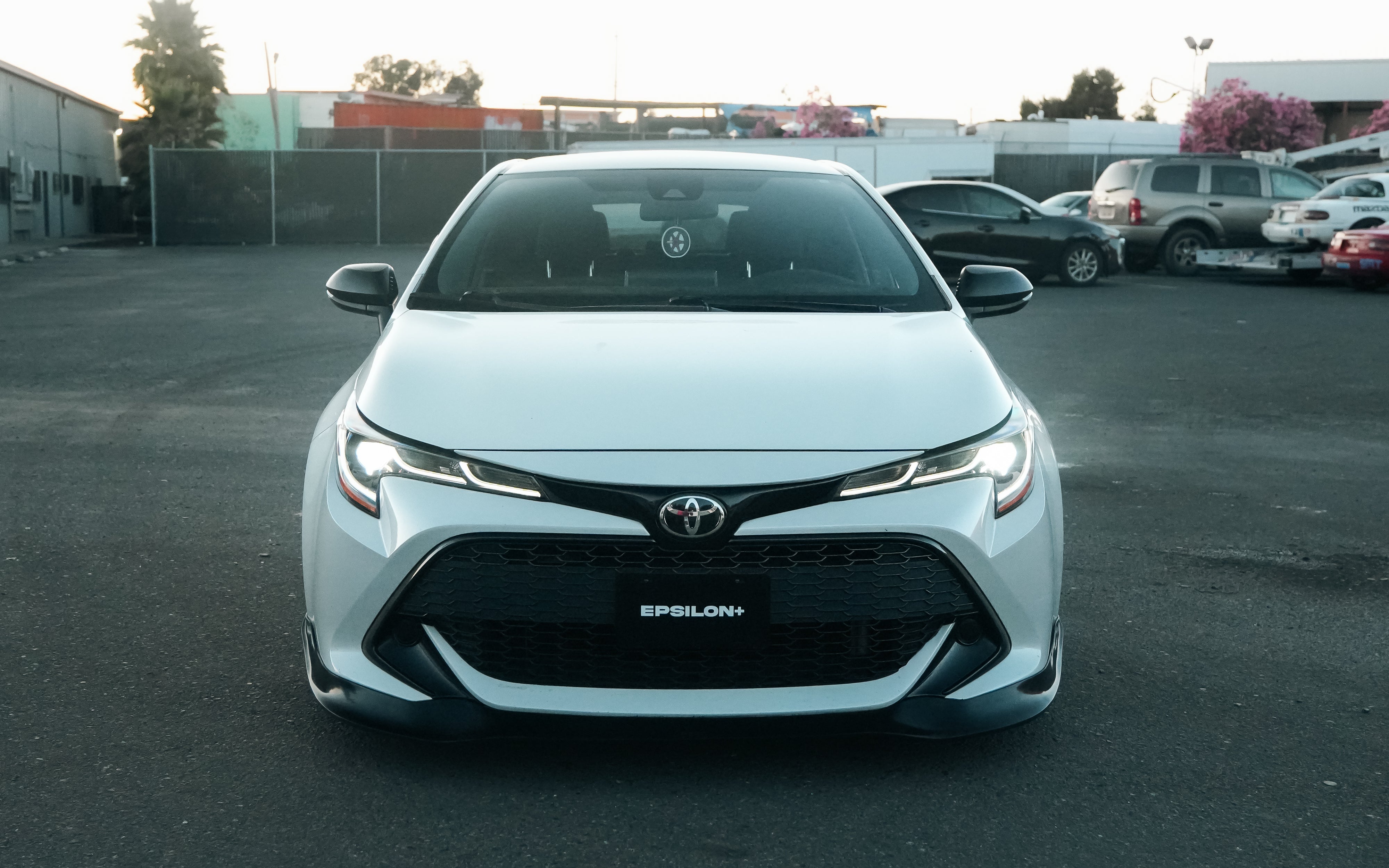 Front-on view of a white Toyota Corolla Hatchback fitted with the Epsilon+ front lip