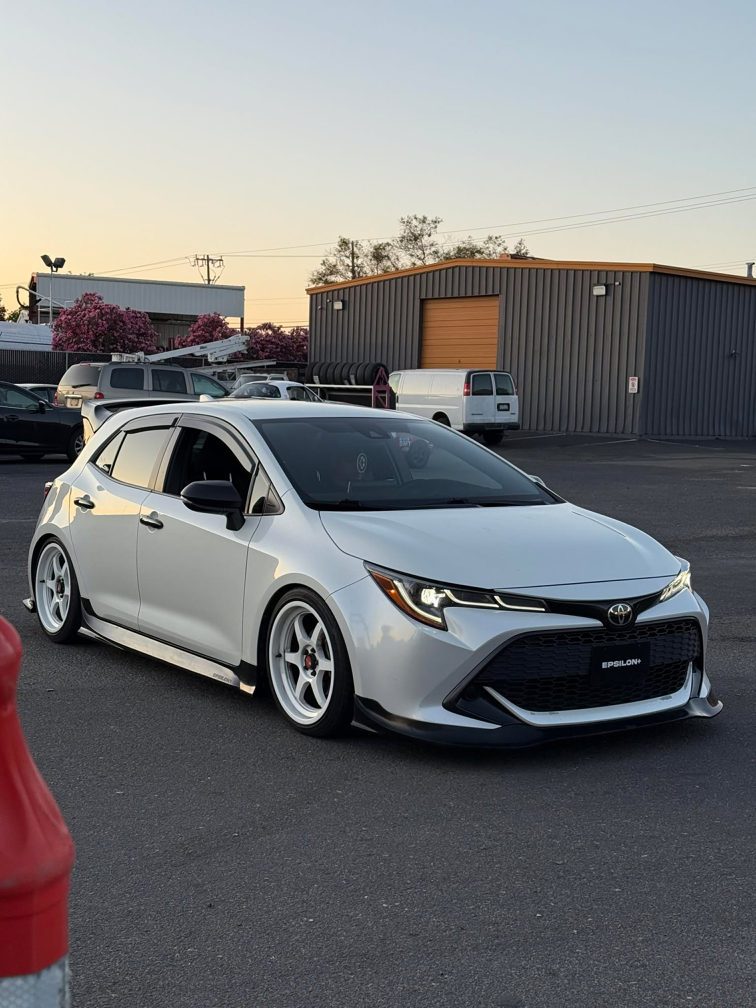 Front three-quarter view of a white Corolla Hatchback with the Epsilon+ front lip
