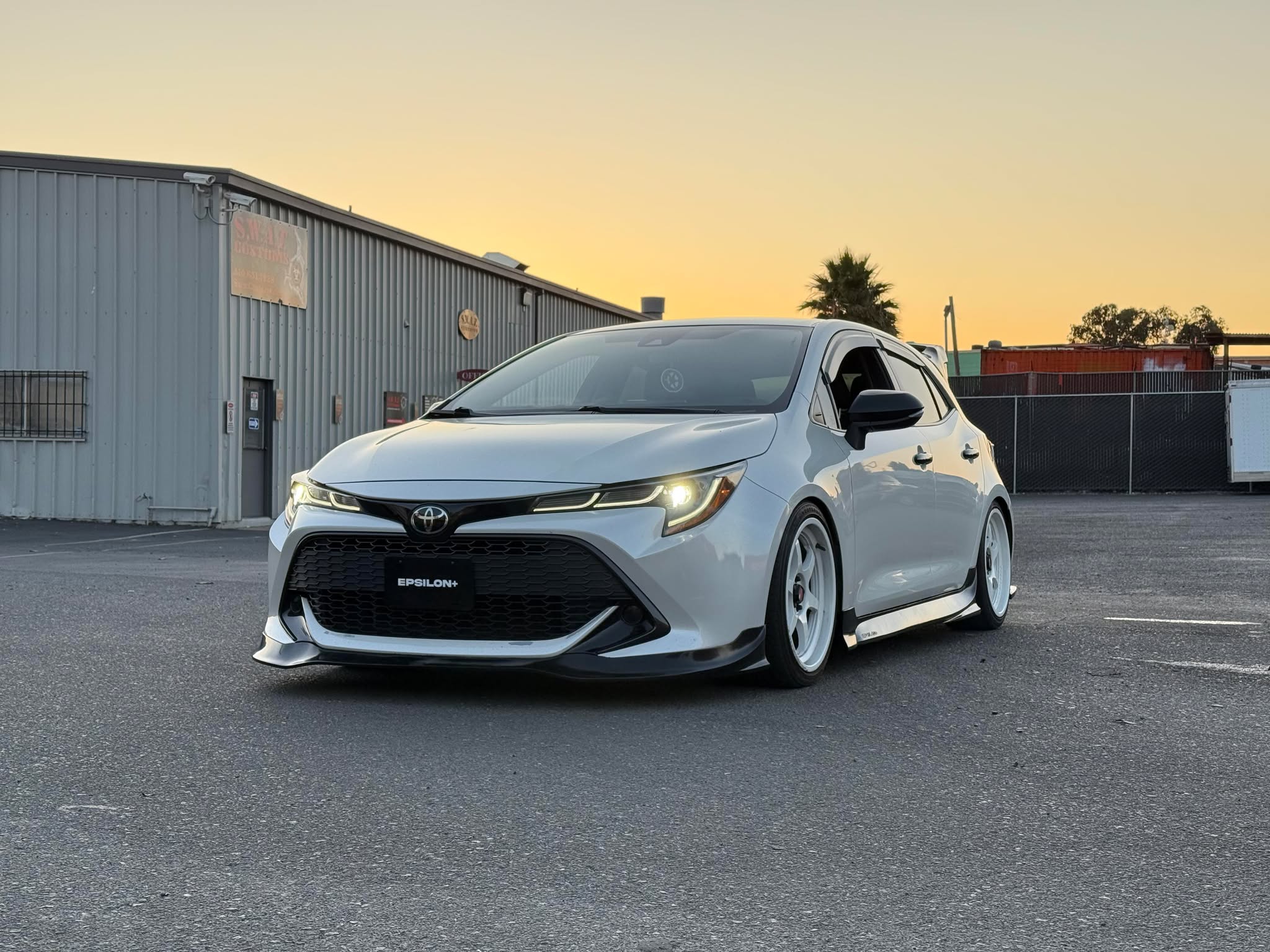 White Toyota Corolla Hatchback with Epsilon+ front lip at sunset