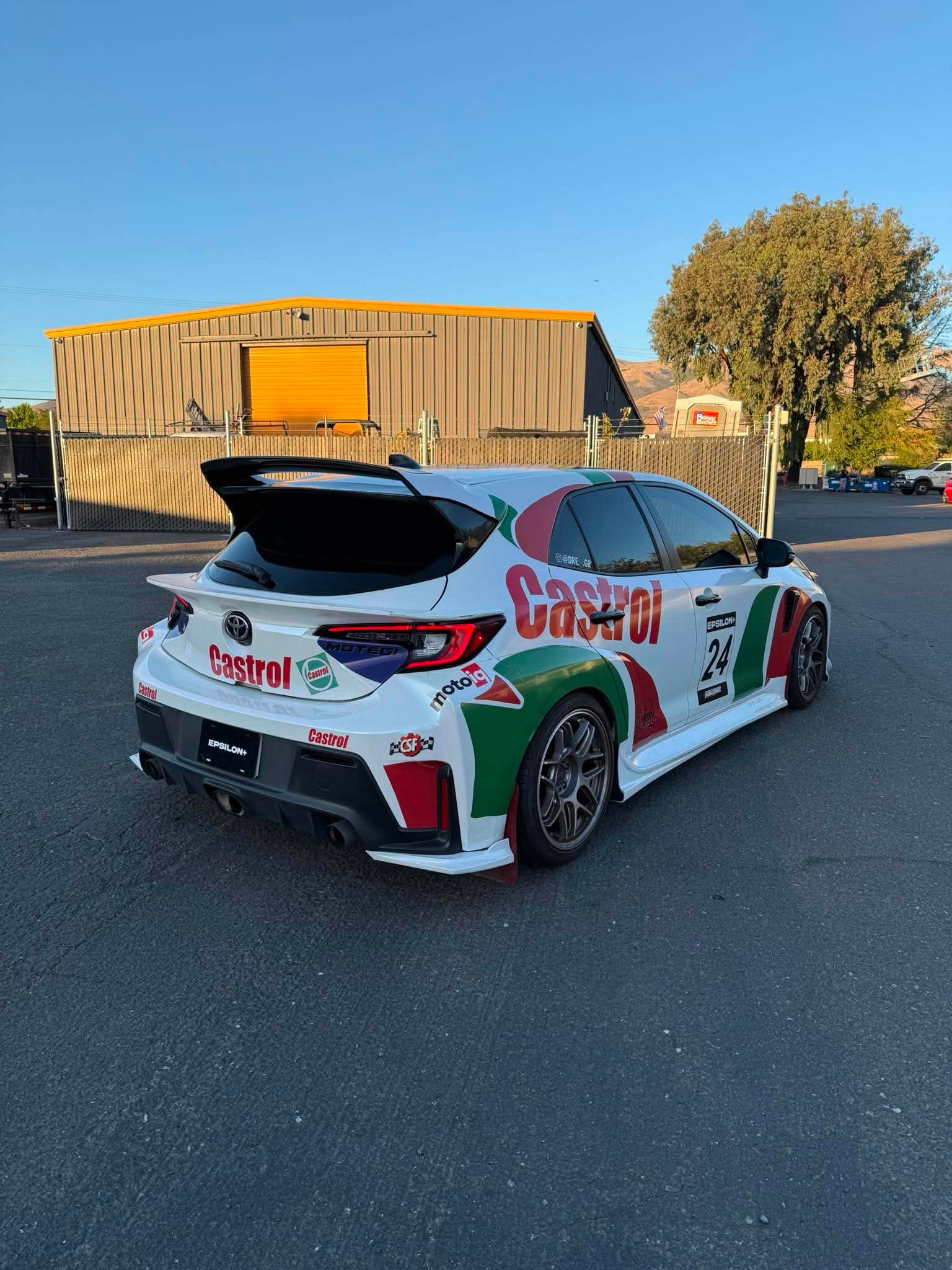 Castrol-liveried Corolla Hatchback with the Epsilon+ mid wing in a parking lot