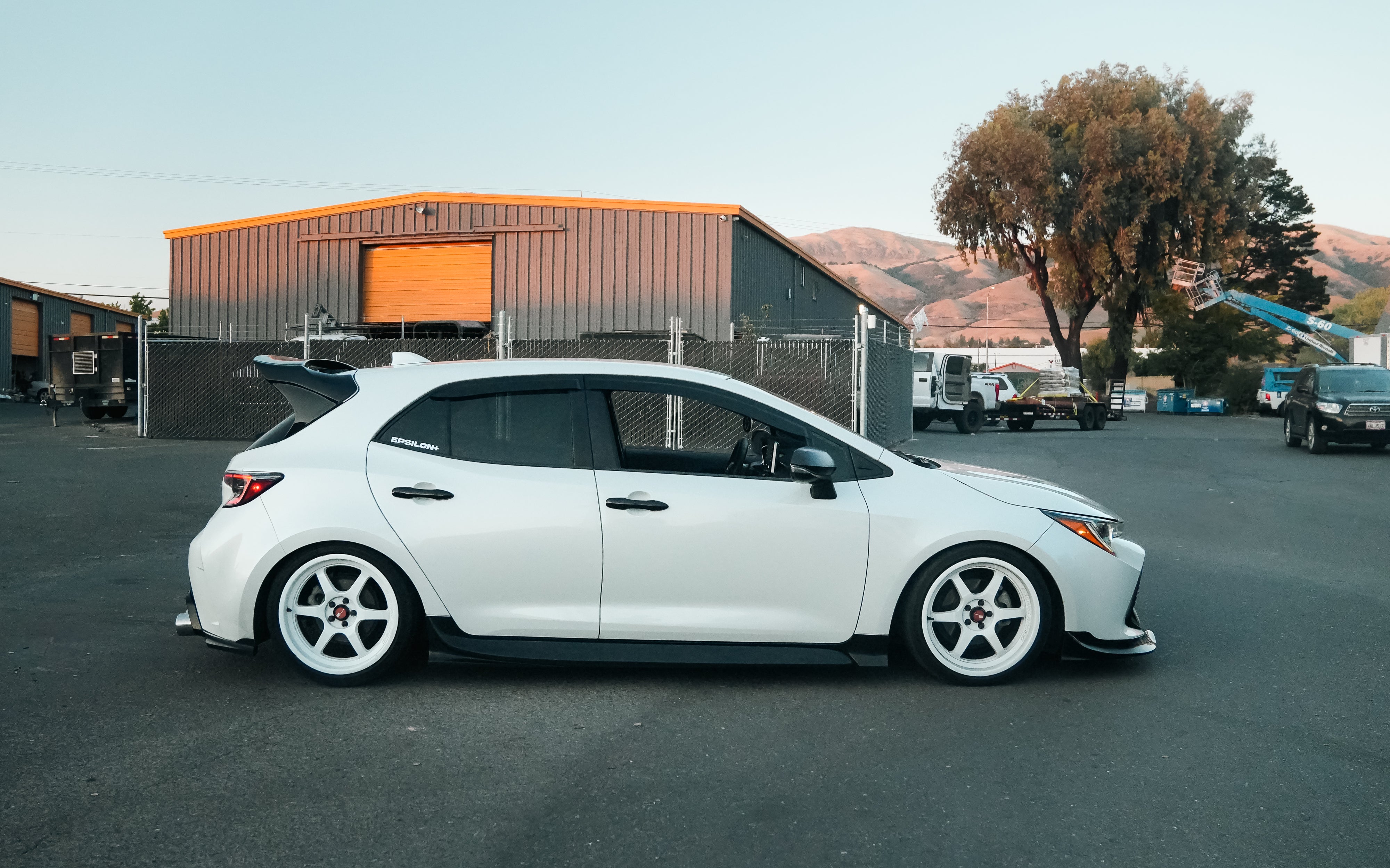 Side-rear view of a white Toyota Corolla Hatchback with Epsilon+ side skirts