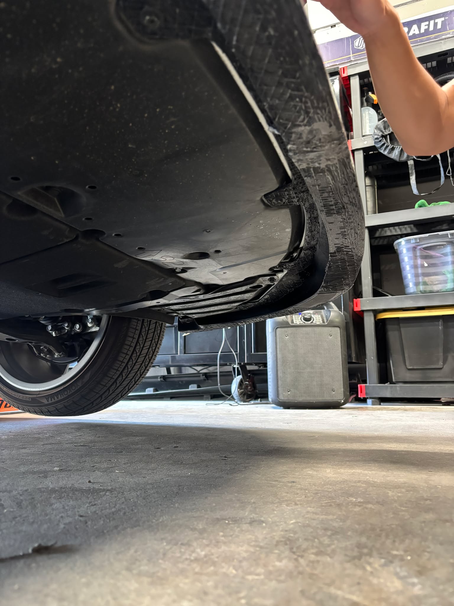 Corolla Hatchback raised on a lift during Epsilon+ front lip installation