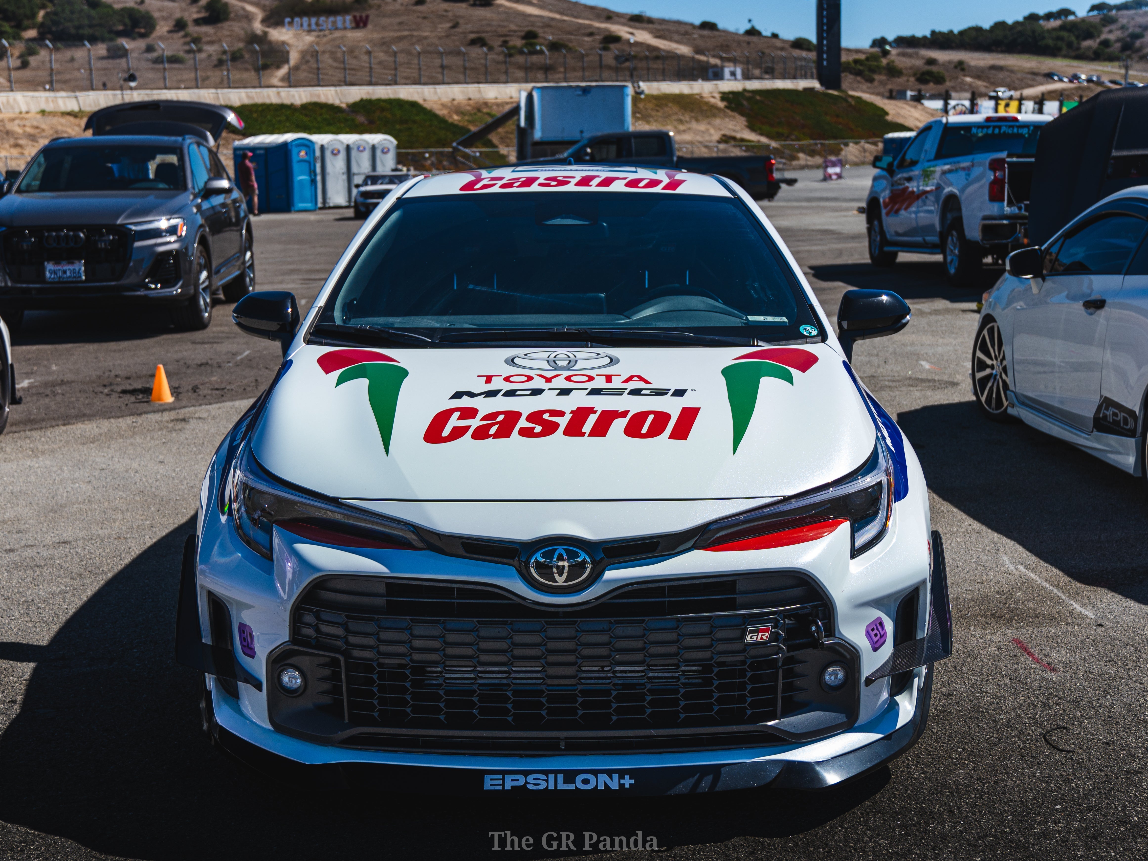 White and blue GR Corolla rally car with canards, race number 24, on display