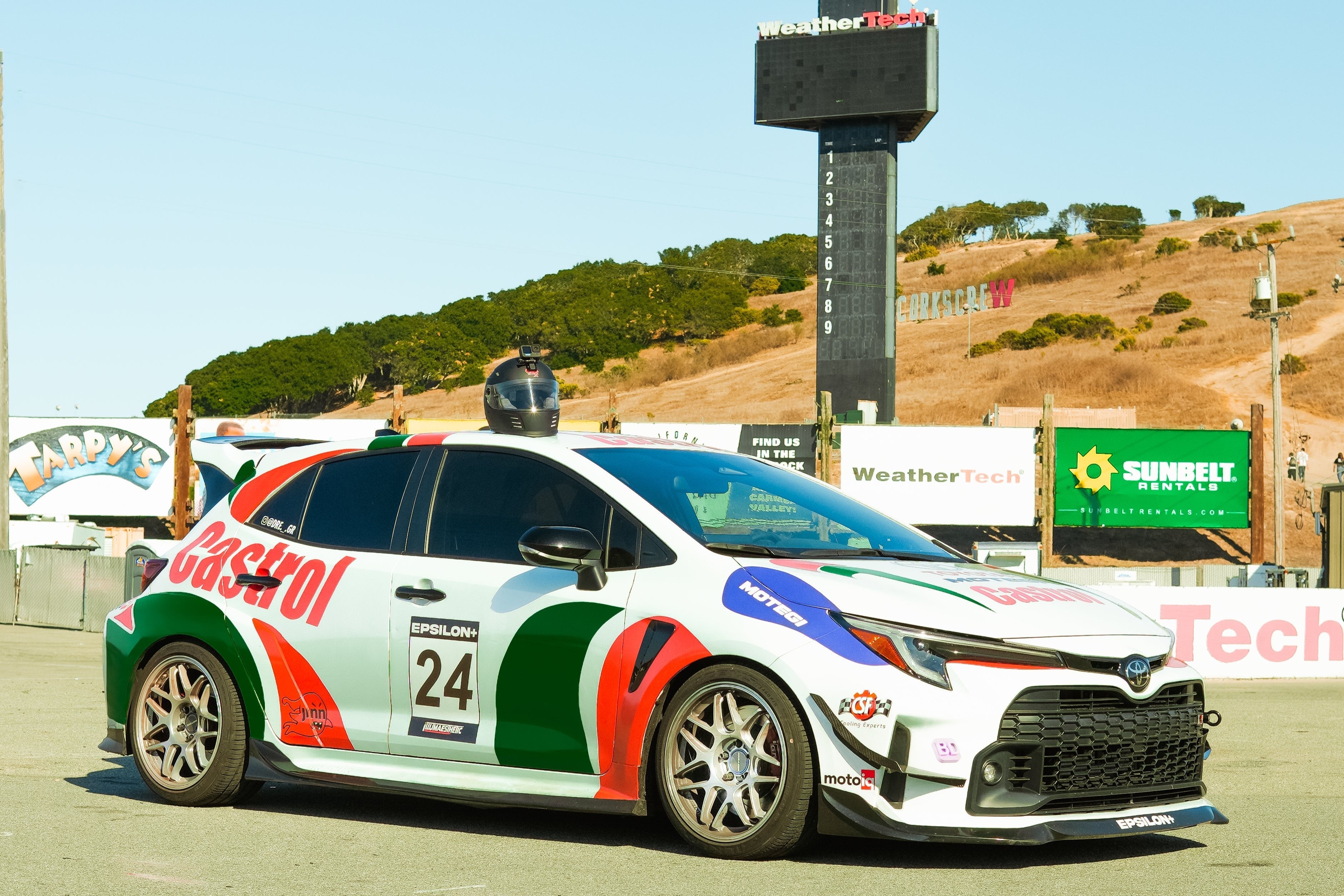 White and blue GR Corolla rally car with canards, race number 24, on a track
