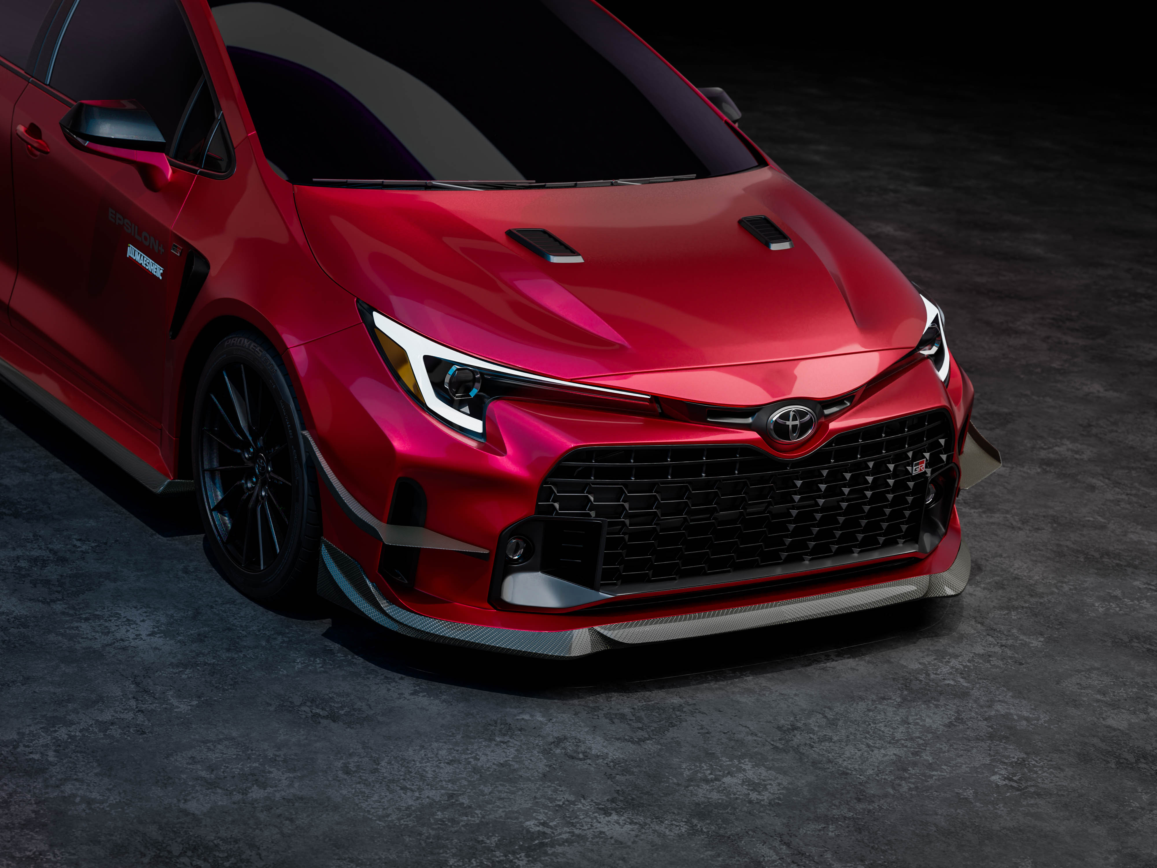 Front three-quarter studio render of a red GR Corolla with canards