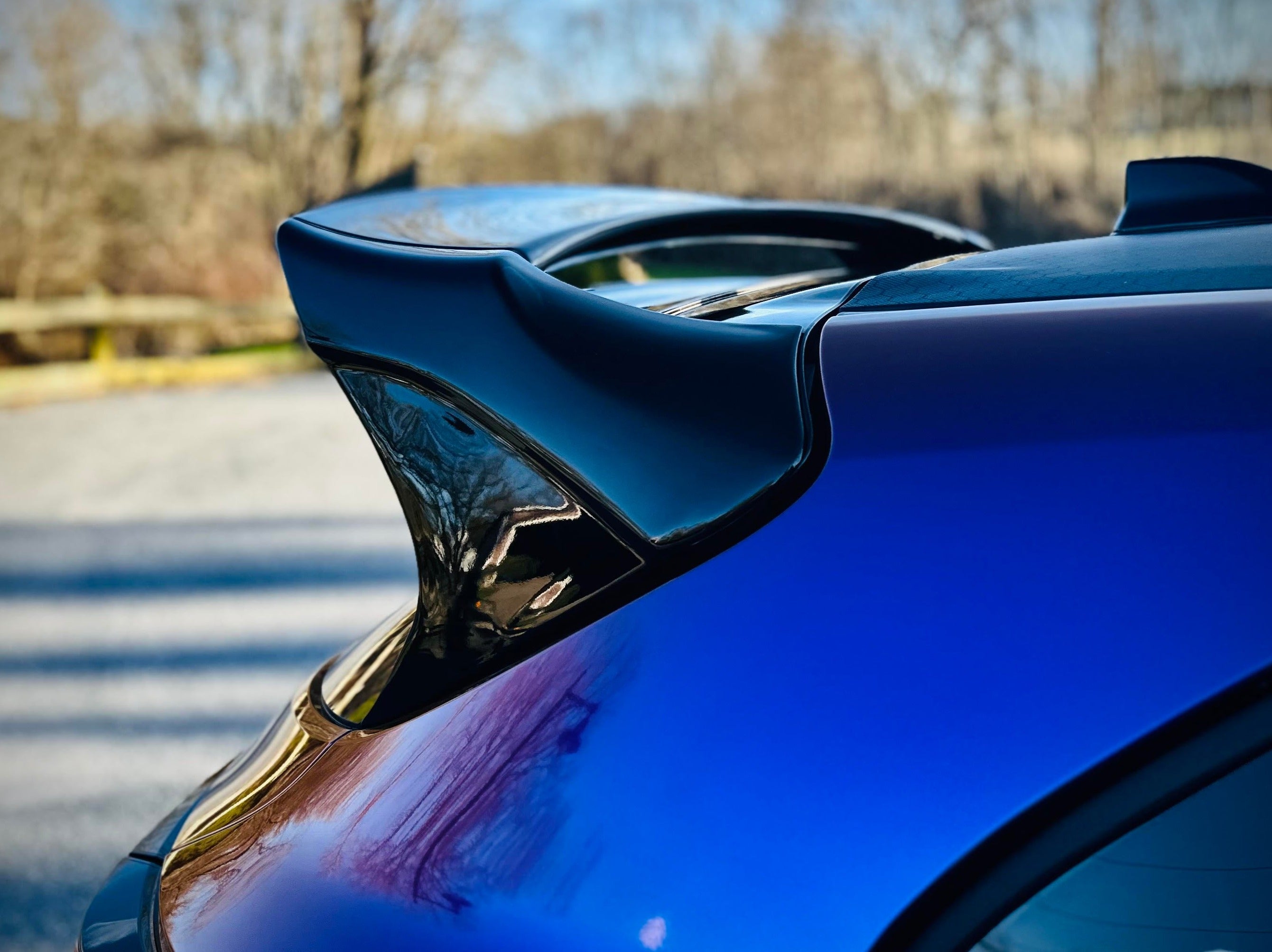 Close-up of the WRC Wing V3 endplate on a blue GR Corolla roofline
