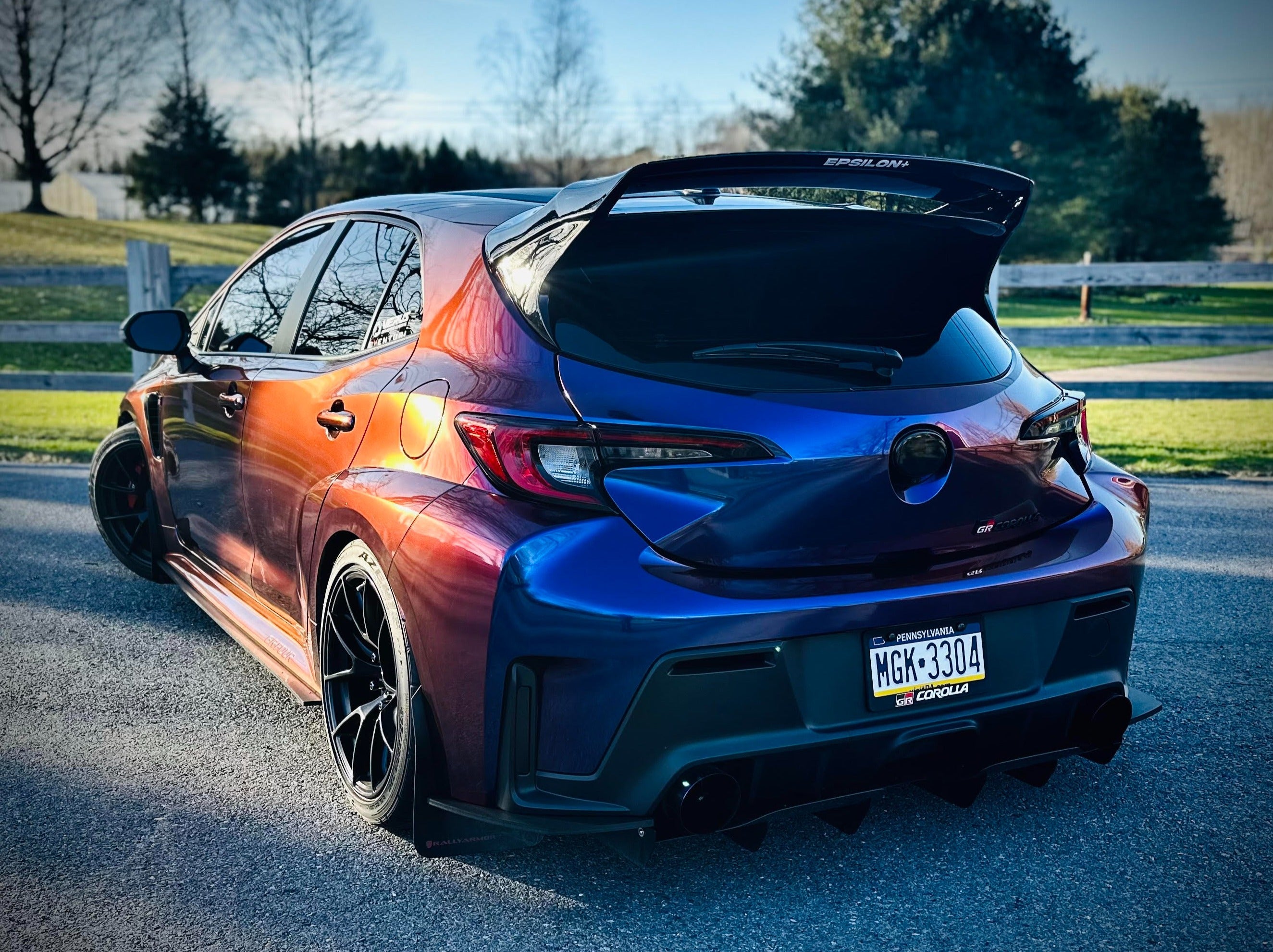 Rear three-quarter view of a purple color-shift GR Corolla with WRC Wing V3