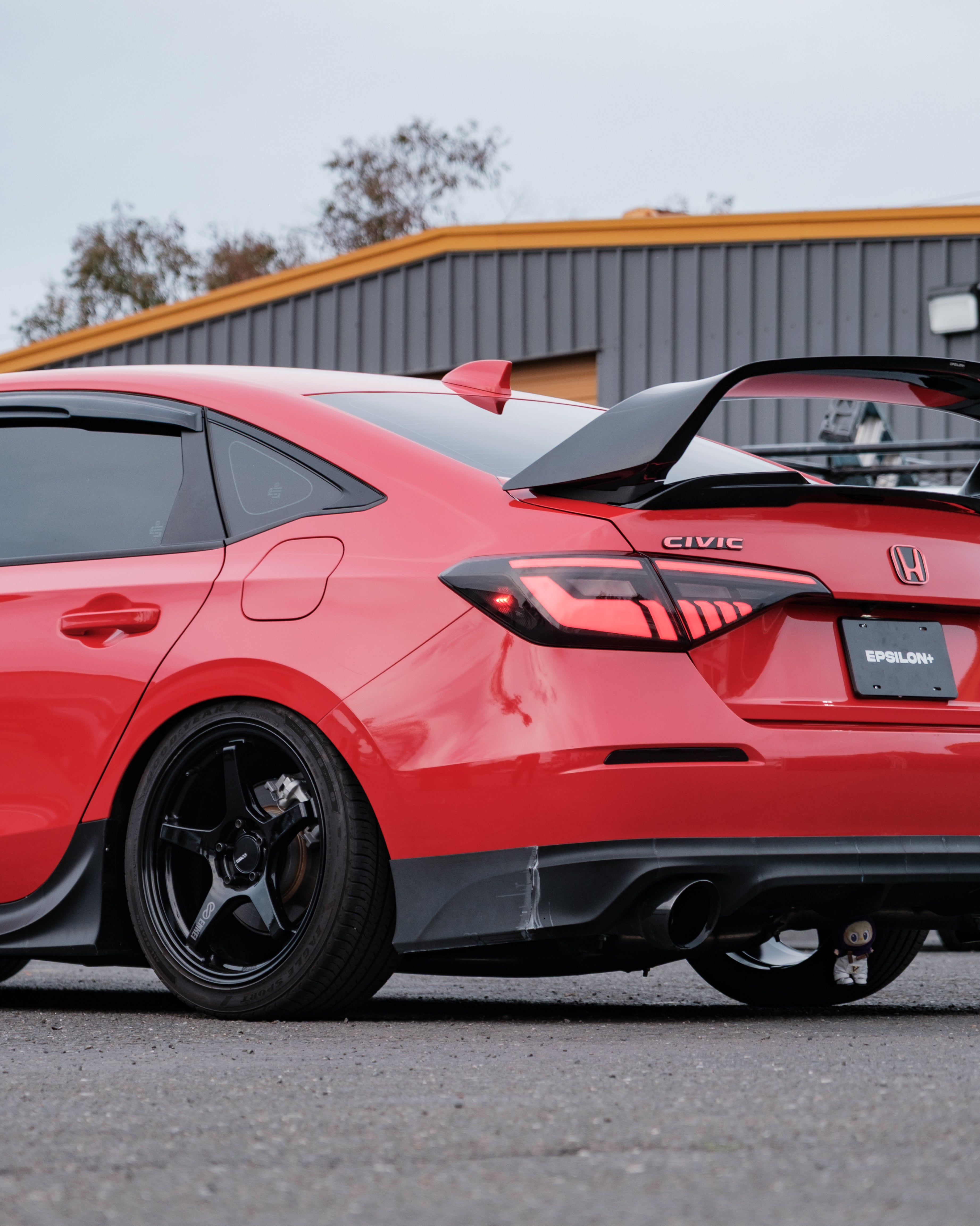 Close rear view of a red Honda Civic FE with the Epsilon+ aero kit