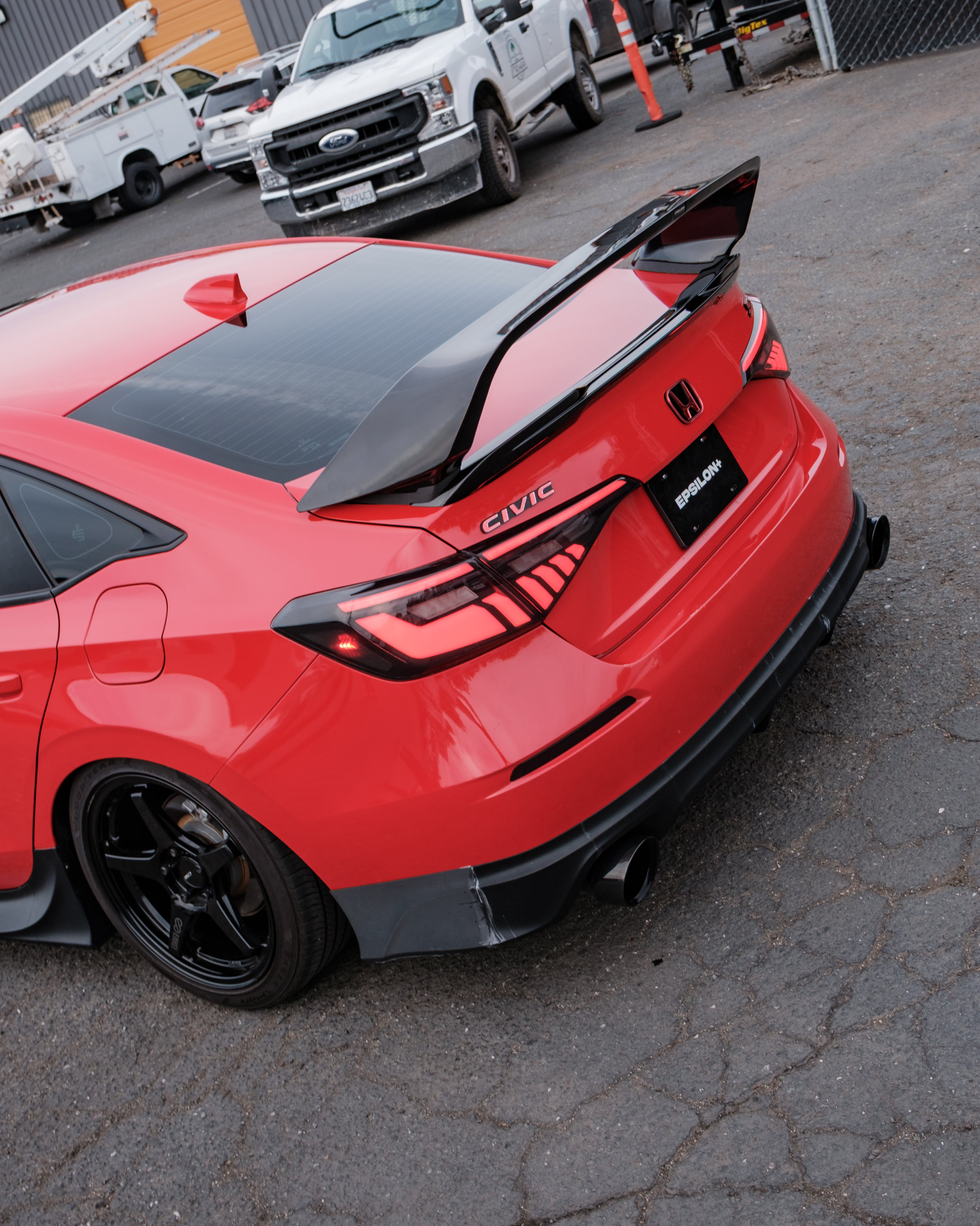 Red Honda Civic FE with the Epsilon+ aero kit and rear wing