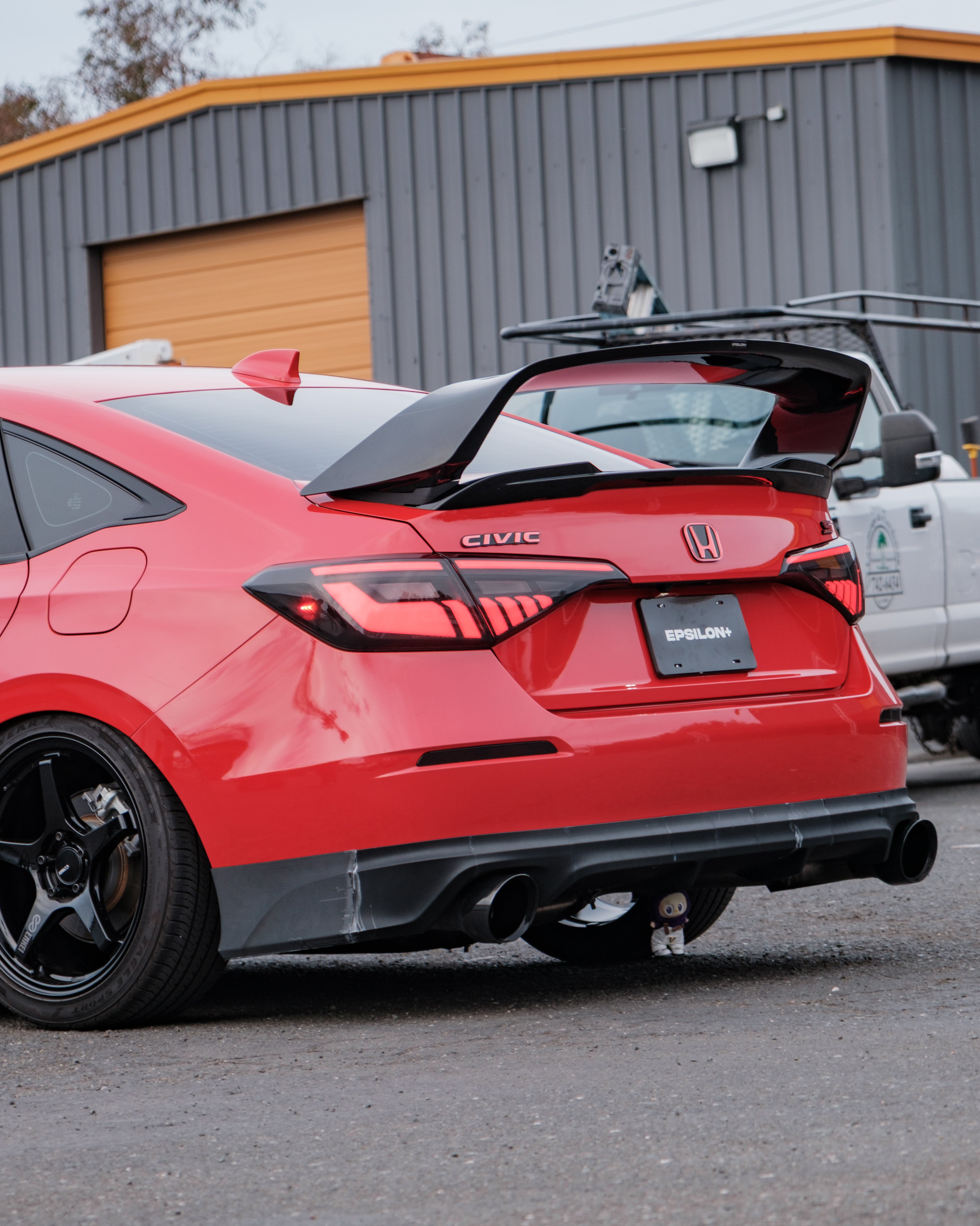 Rear three-quarter view of a red Honda Civic FE with the Epsilon+ aero kit