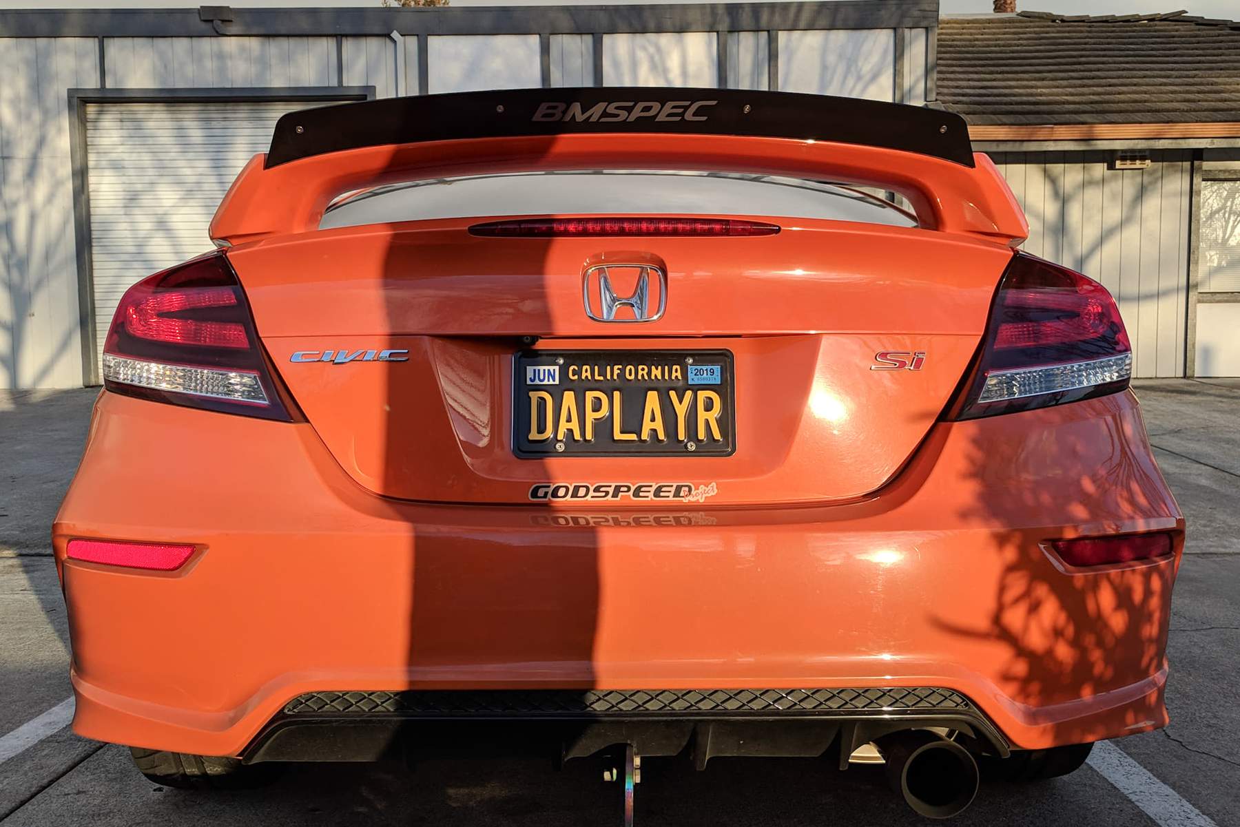 Rear view of an orange Civic Si Coupe FG4 Kouki with spoiler extension
