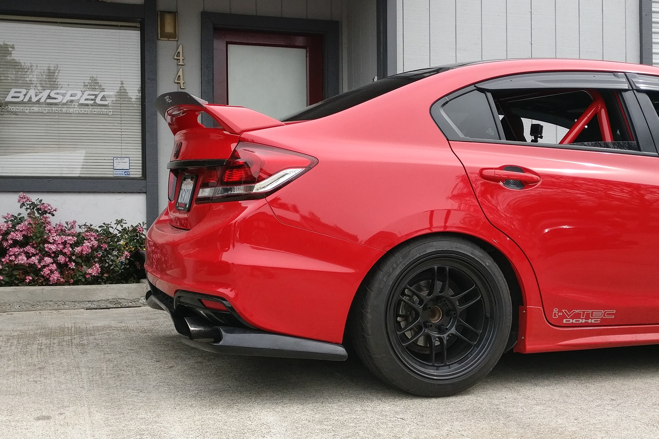 Rear three-quarter view of a red Civic Si Sedan FB6 Kouki with spoiler extension