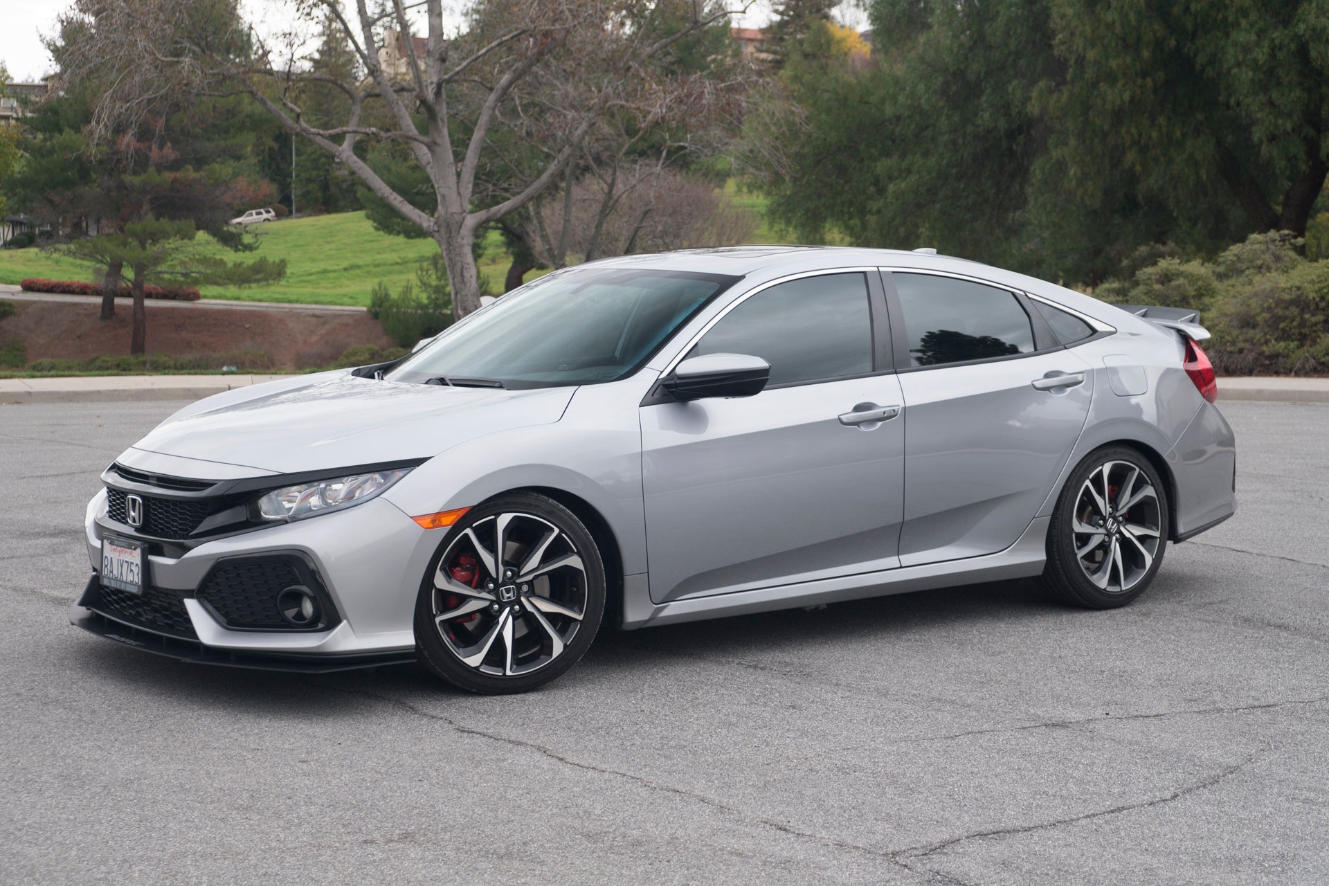 Side profile of a silver Honda Civic Si Sedan with Epsilon+ front lip installed