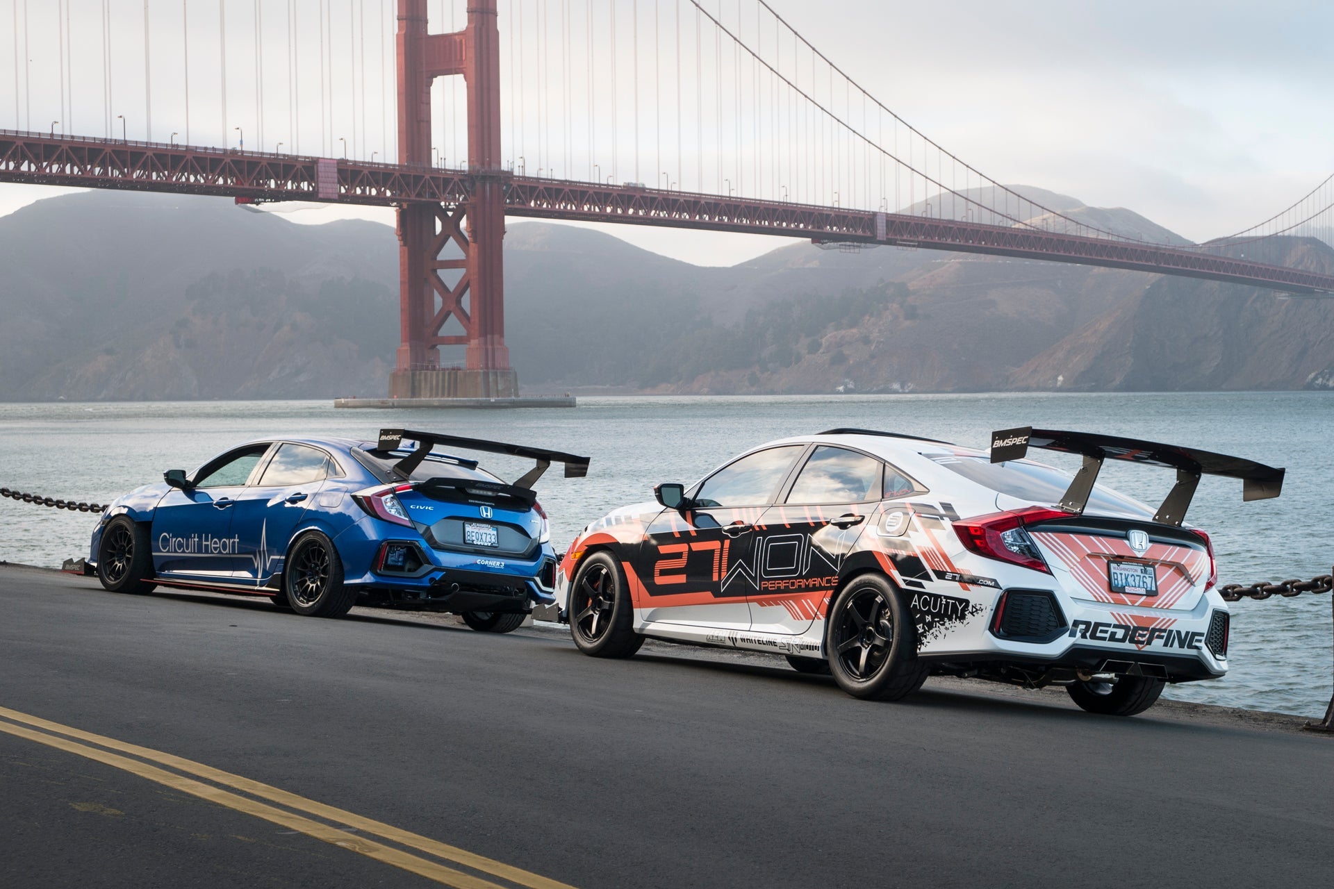 Group of Civic motorsport cars with GT wings parked near the Golden Gate Bridge