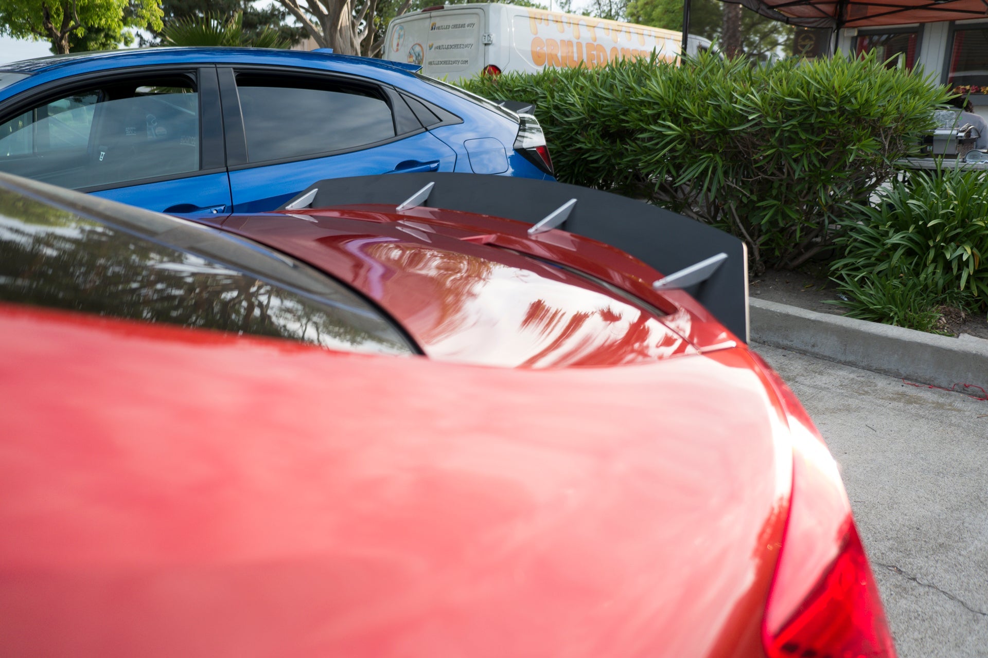 Close-up of the spoiler extension on a red Civic Si Coupe Zenki trunk