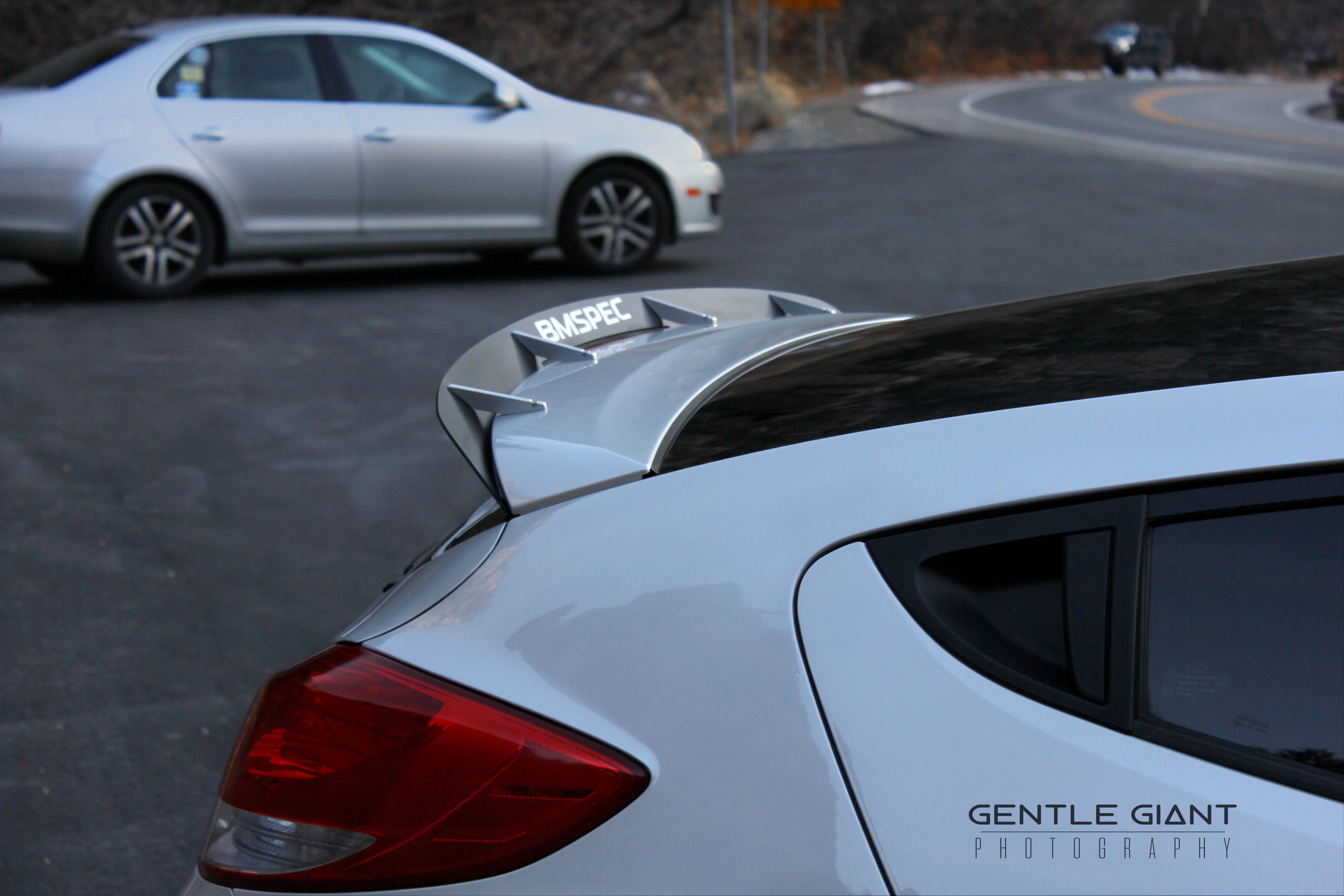 Close-up of the spoiler extension on a white Hyundai Veloster Turbo roofline