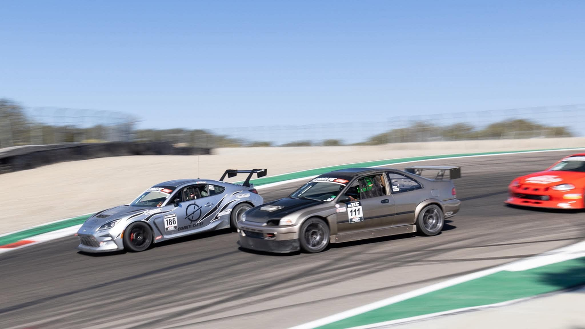 Silver Toyota GR86 ZN8 race car with the Epsilon+ TC wing racing wheel to wheel through a corner