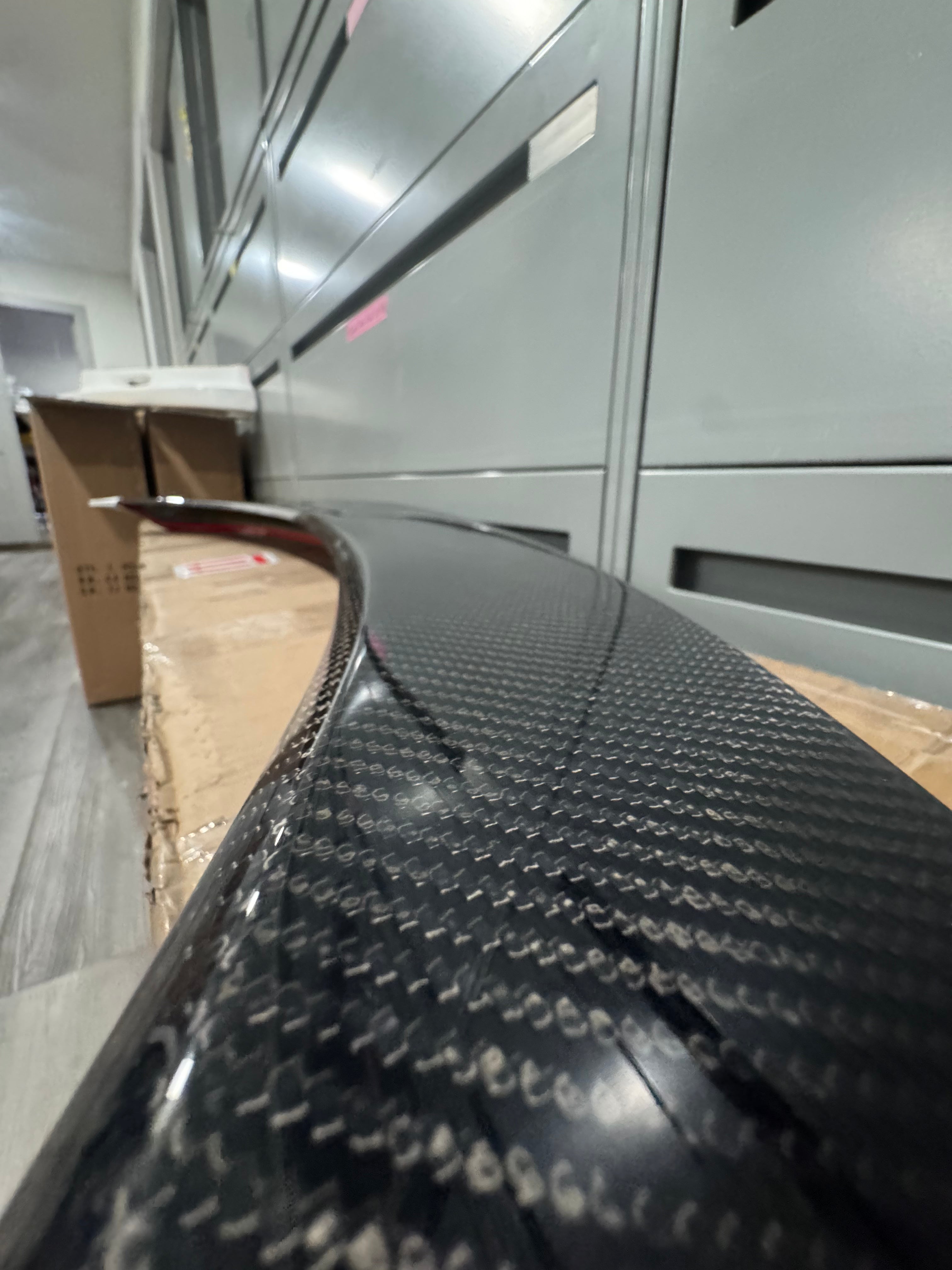 Close-up of the carbon fiber weave on the Epsilon+ Integra rear trunk lip